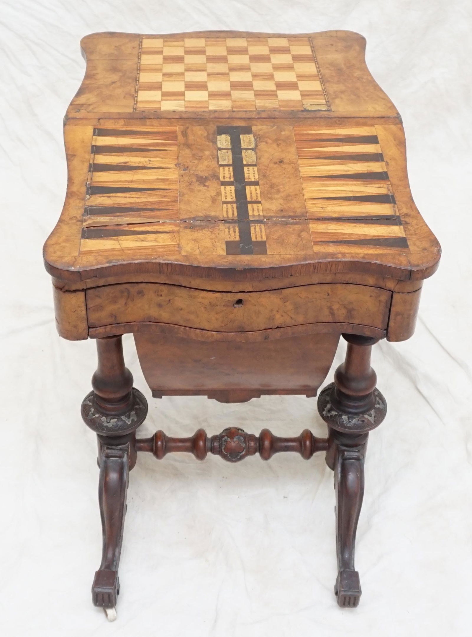 19th c INLAID GAMES TABLE SEWING STAND: Antique 19th c. Victorian Burled Walnut Inlaid Games Table Sewing Stand circa 1880. Measures 21"x15"x30" Closed. Table Top opens to 30". Included is a box of carved wood chess pieces. Some Wear and Sp