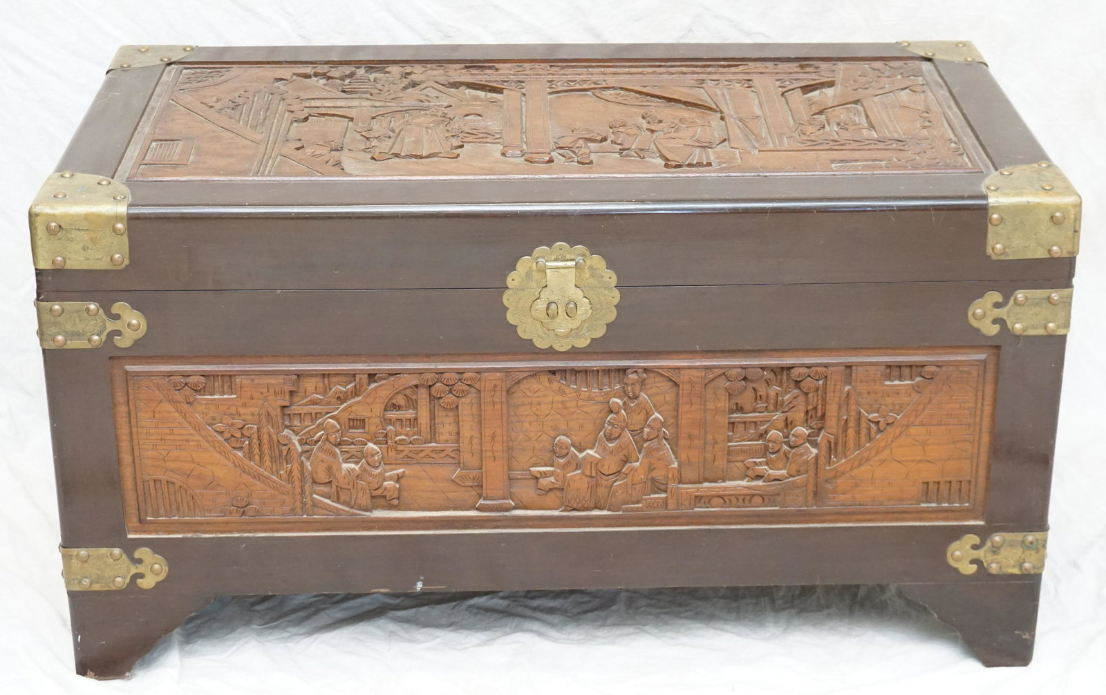 MID CENTURY CHINESE CARVED CHEST: Mid Century Chinese carved teak and camphor chest by George Zee and Co. The chest has skillfully carved cartouches of courtly scenes, interior sliding drawer, brass hardware and a chinese lock. . 39"2