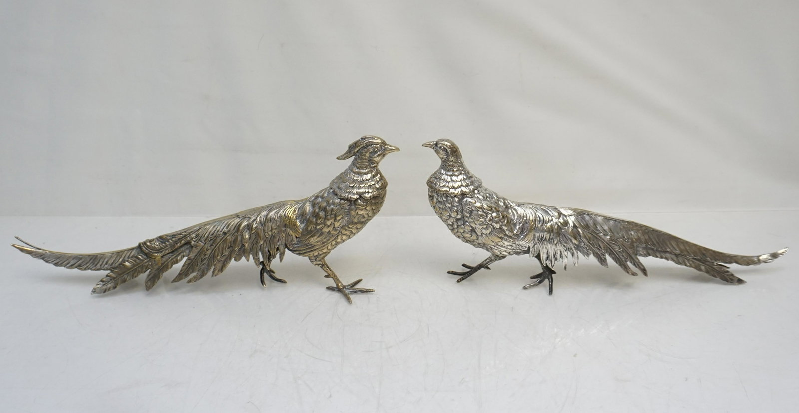 PAIR OF GERMAN SILVER PHEASANT DECANTERS: A pair of Alpacca German Nickel Silver Figural Pheasant Decanters. Male and Female. Both Approximately 13" long. Weight 2 pds 8 oz. PROVENANCE: The Estate of Dr. Fraser Wilson, Charleston SC. Dr. Wils
