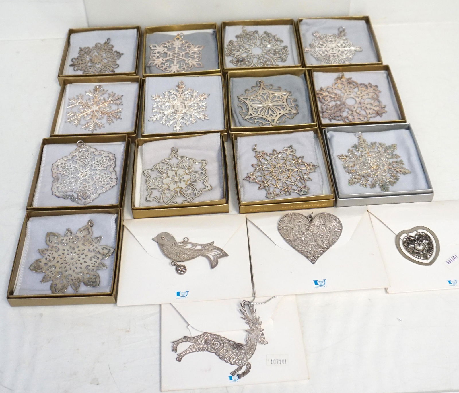 17 STERLING SILVER METROPOLITAN ORNAMENTS: 17 Sterling Silver Holiday Ornaments all from The Metropolitan Museum of Art in New York. In Original Boxes / Packaging. All are Sterling 1- Filigree Oak Leaf. 2- Filigree Heart . 3- Filigree Bird. 4-