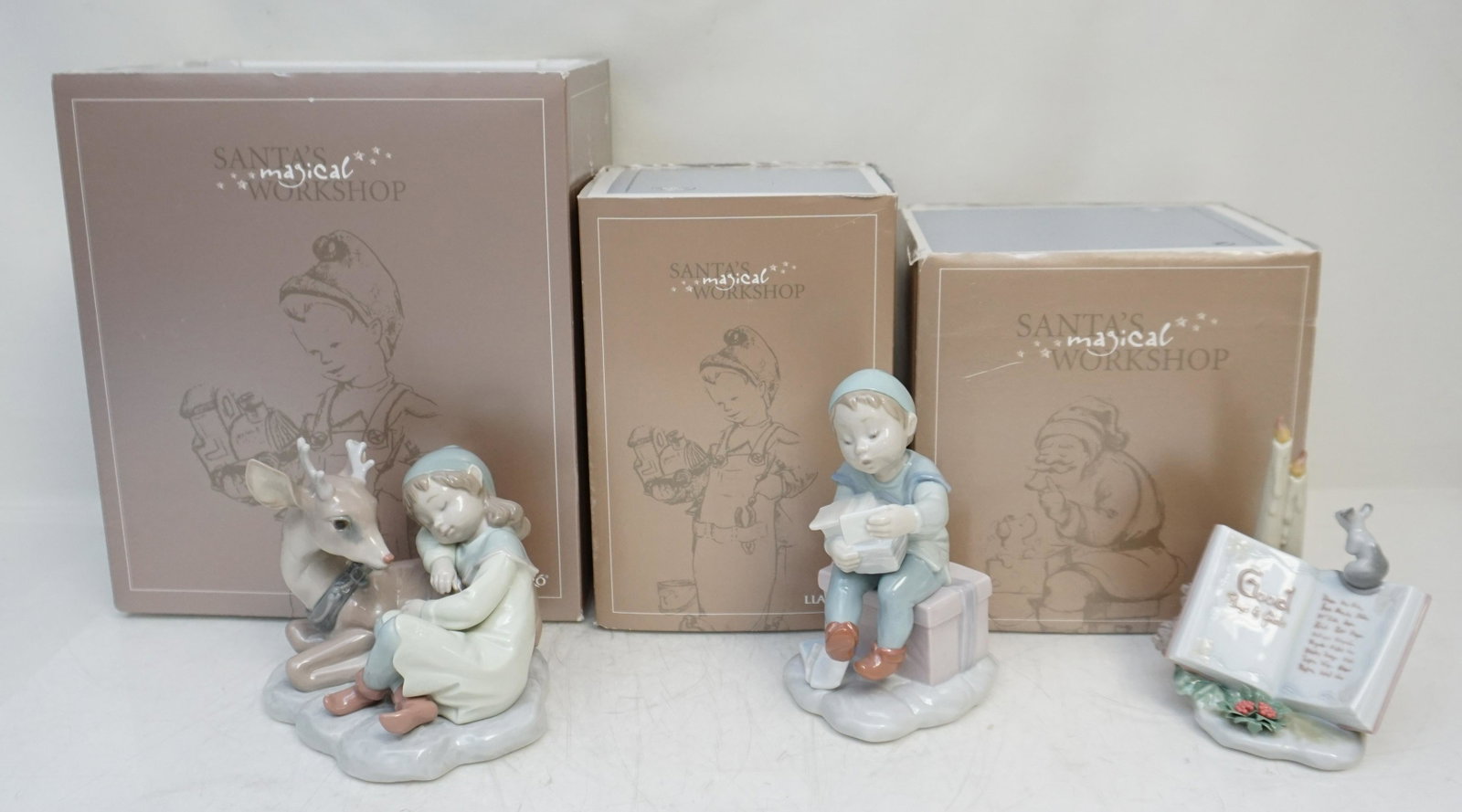 3 LLADRO PORCELAIN SANTAS MAGICAL WORKSHOP: All in original boxes. 1- A Well Earned Rest #01006897. Figurine 4 3/4" Retired 2008. Box 9"x10"x6". 2- Good Boys and Girls #01006896. Figurine 5 1/4". Retired 2008. Box 6"x7"x7". 3- Delivering Magic 
