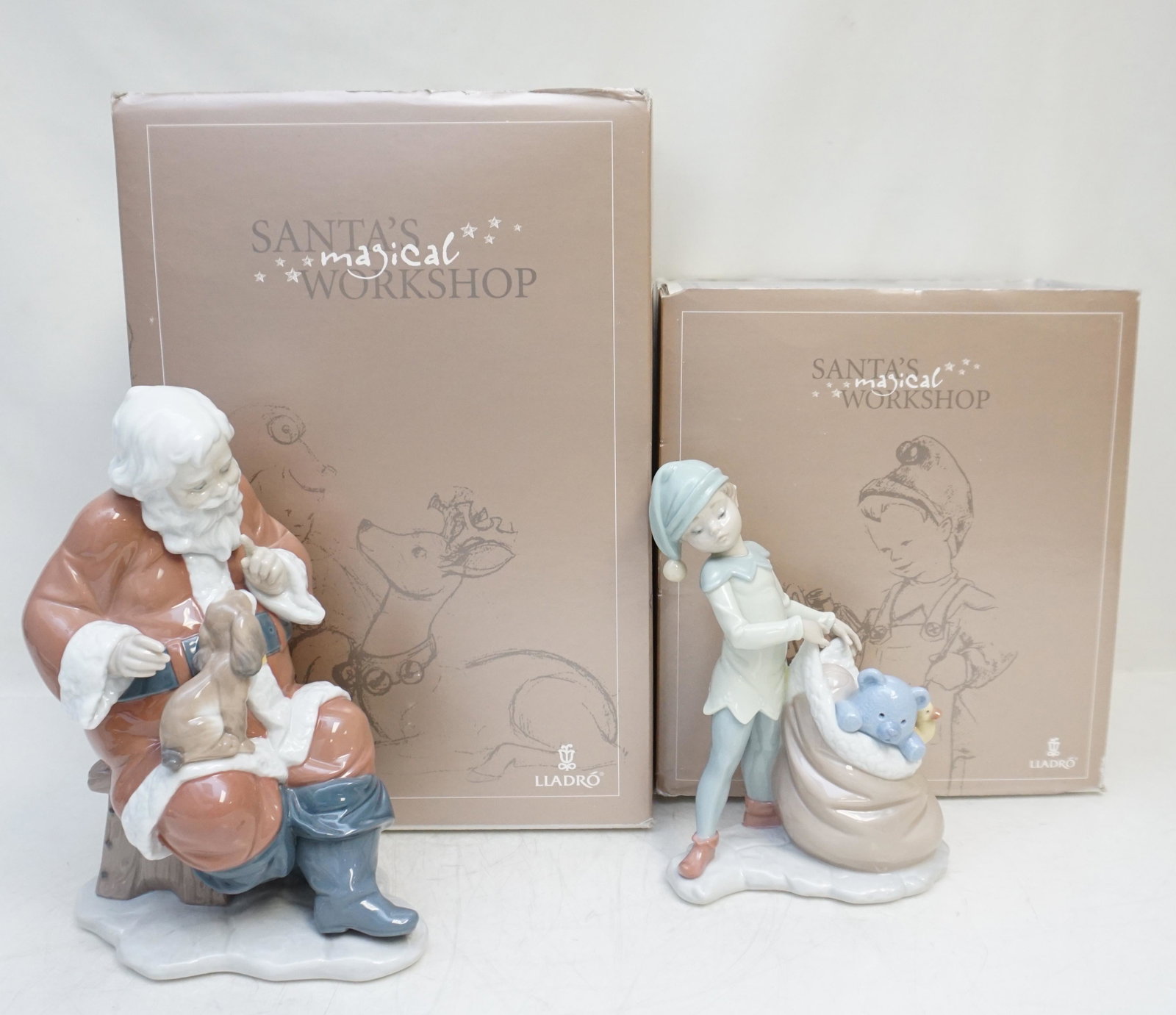 2 LLADRO PORCELAIN SANTAS MAGICAL WORKSHOP: All in original boxes. 1- Santa's Little Secret #6890. Figurine 9" Retired 2013. Box 9"x14"x8". 2- Santa's Sack of Dreams #6894. Figurine 7 1/2" Box 10"x10"x9" Weight on all 8 pds. PROVENANCE: A Priva