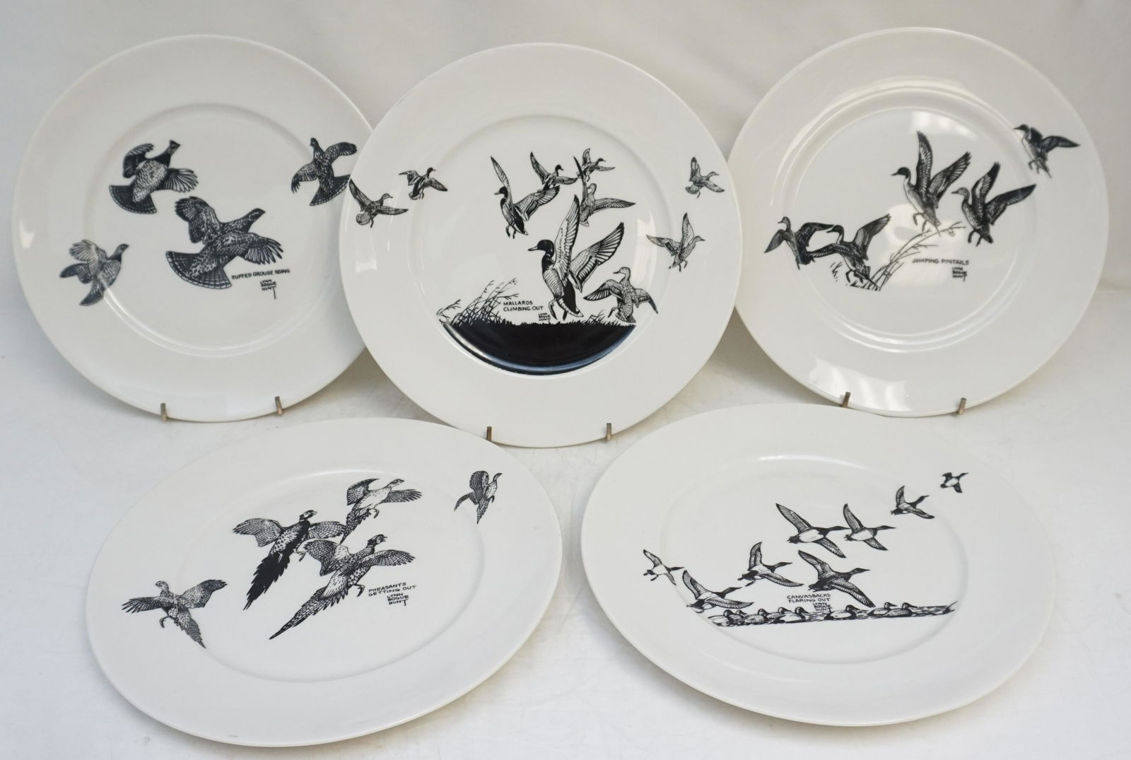 LYNN BOGUE HUNT GAME BIRD PLATES: A Set of Five 1940s China Plates with Black and White Game Bird Designs by Lynn Bogue Hunt, with his own descriptions on the backs of the plates. On the back of each plate is shown a pair of the subje