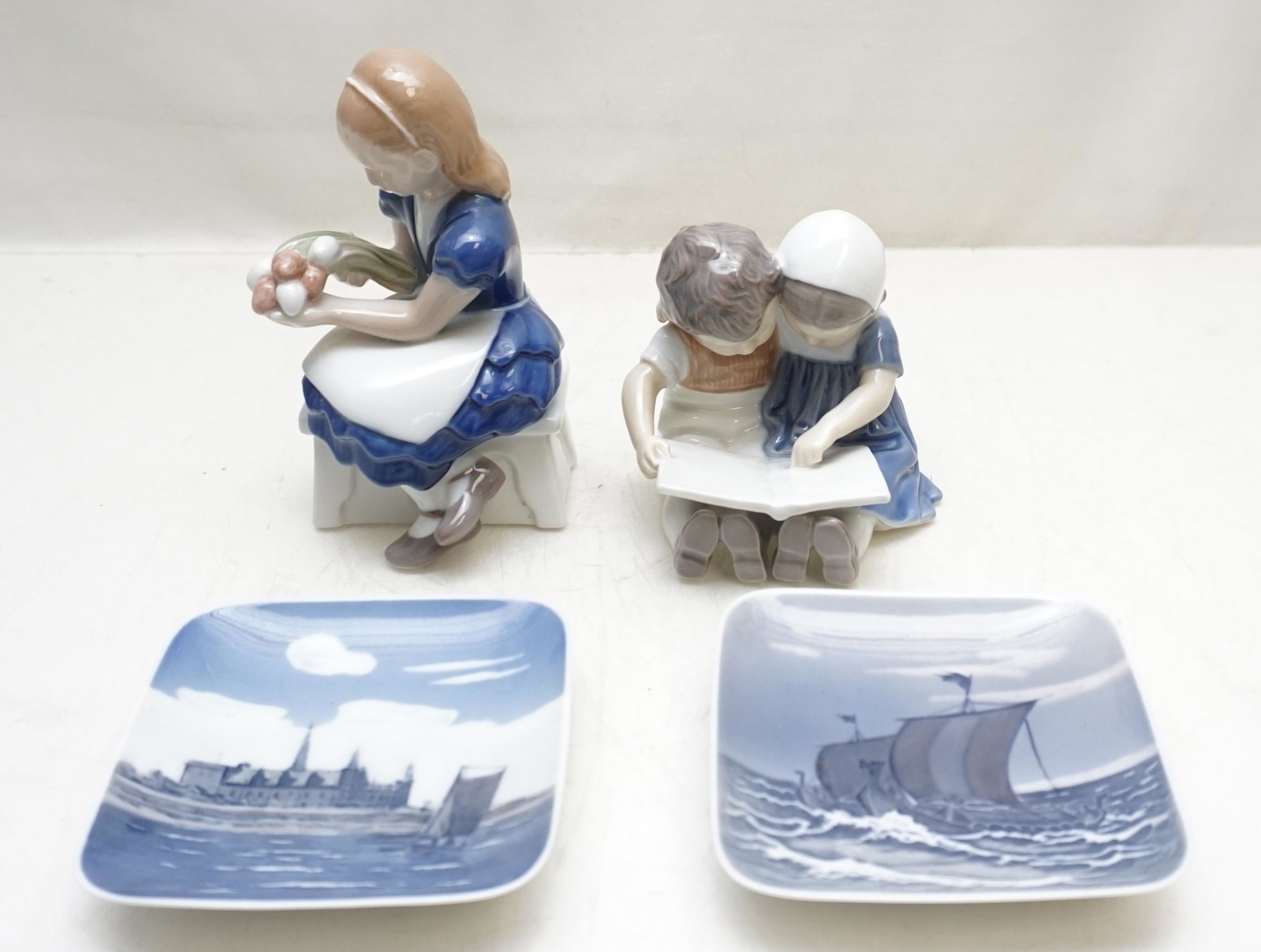 4 PC BING & GRONDAHL PORCELAIN: All Vintage Bing & Grondahl, all in good condition. 1- Girl with Tulips 6". 2- Boy and Girl Reading 3 3/4". 3- Two Square Plates Small 4 1/2". Weight on all 2 pds 6 oz. PROVENANCE: A Private Charlesto