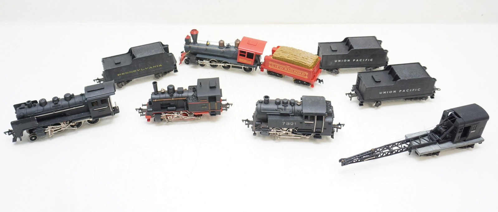 8 VINTAGE ELECTRIC TRAINS: All are Vintage. Tyco Hooterville Cannonball Petticoat Junction HO scale Engine and "C. & F.W. Railroad" tender. Two Fleischmann Union pacific Coal Tenders and 1 Philadelphia. Fleischmann 1320 Steam L