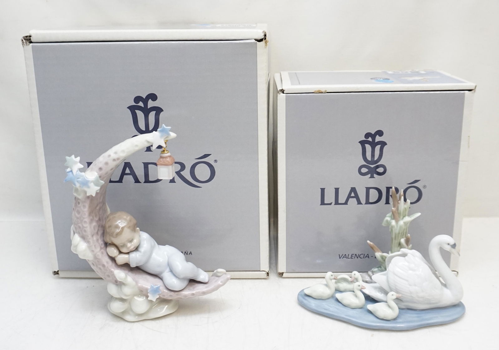 2 LLADRO PORCELAIN FIGURINES: Both in original boxes. Excellent condition. 1- Heavenly Slumber #6479. Figurine 7 1/4". Box 10"x9"x6 1/2". 2- Follow Me #5722. Retired. Figurine 7 1/8"x4 1/2". In box 7 1/2"x4 1/2"x8". Weight on all