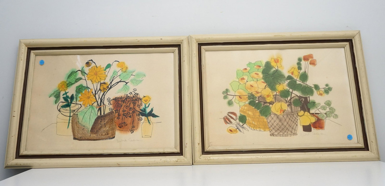 PAIR OF MID CENTURY BABETTE EDDELSTON PRINTS: Pair mid century hand colored prints, signed in pencil by Babette Eddleston (1922-1990). Circa 1960s. The prints have additional hand-painted color applied by artist. In matching cream wood frames und