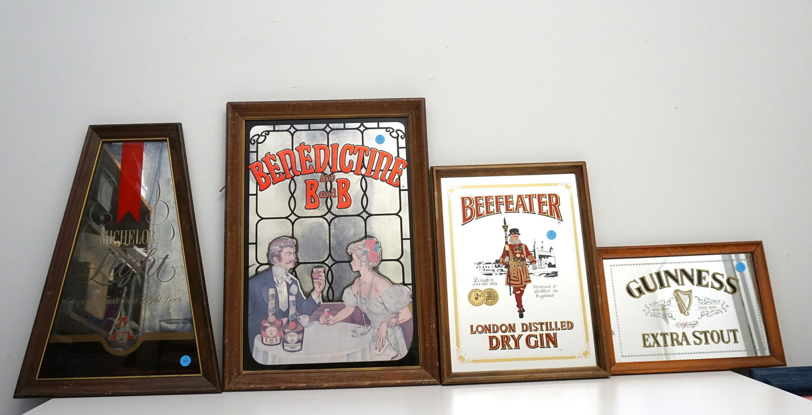 4 VINTAGE BAR MIRRORS: Four Vintage Decorative Bar Mirrors. 1- Michelob Light 14"x20"x1". 2- Benedictine and B and B 15 1/2"x21 1/2"x1". 3- Beefeater London Distilled Dry Gin 12"x16"x1". 4- Guinness Extra Stout 13 1/4"x9 1/