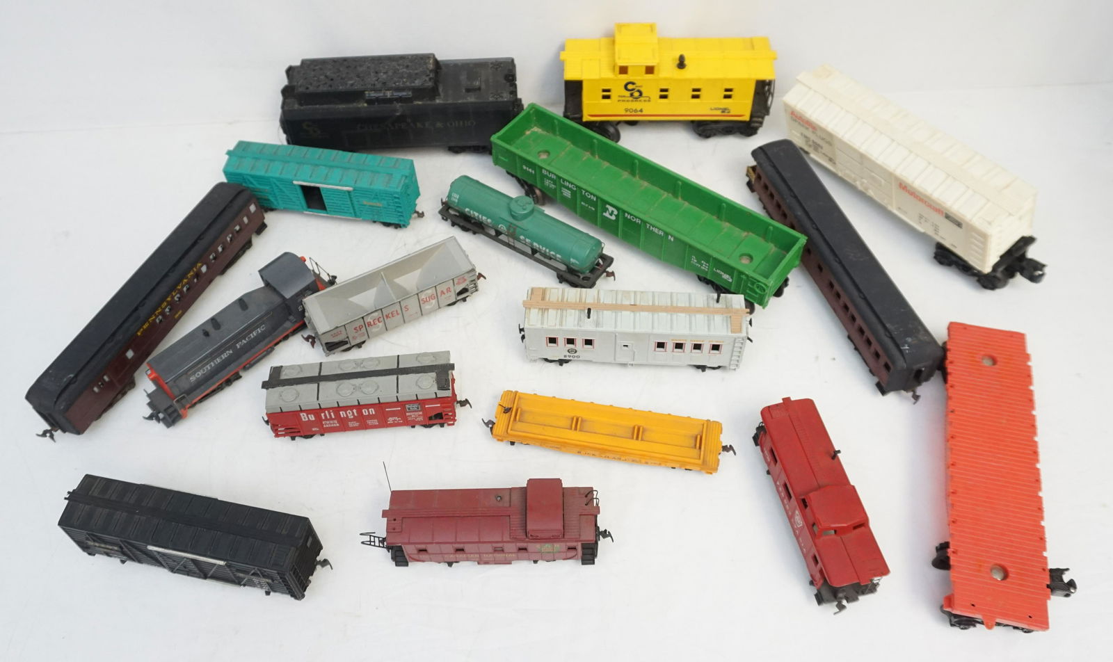 16 VINTAGE TRAIN ENGINES - CARS ETC: Large Group of Vintage Train Engines and Cars. Includes a Lionel Chesapeake and Ohio C & O 9064 Caboose, Athearn HO Scale Southern Pacific 2286 Diesel Engine, Penn Line HO Passenger Cars and More. See