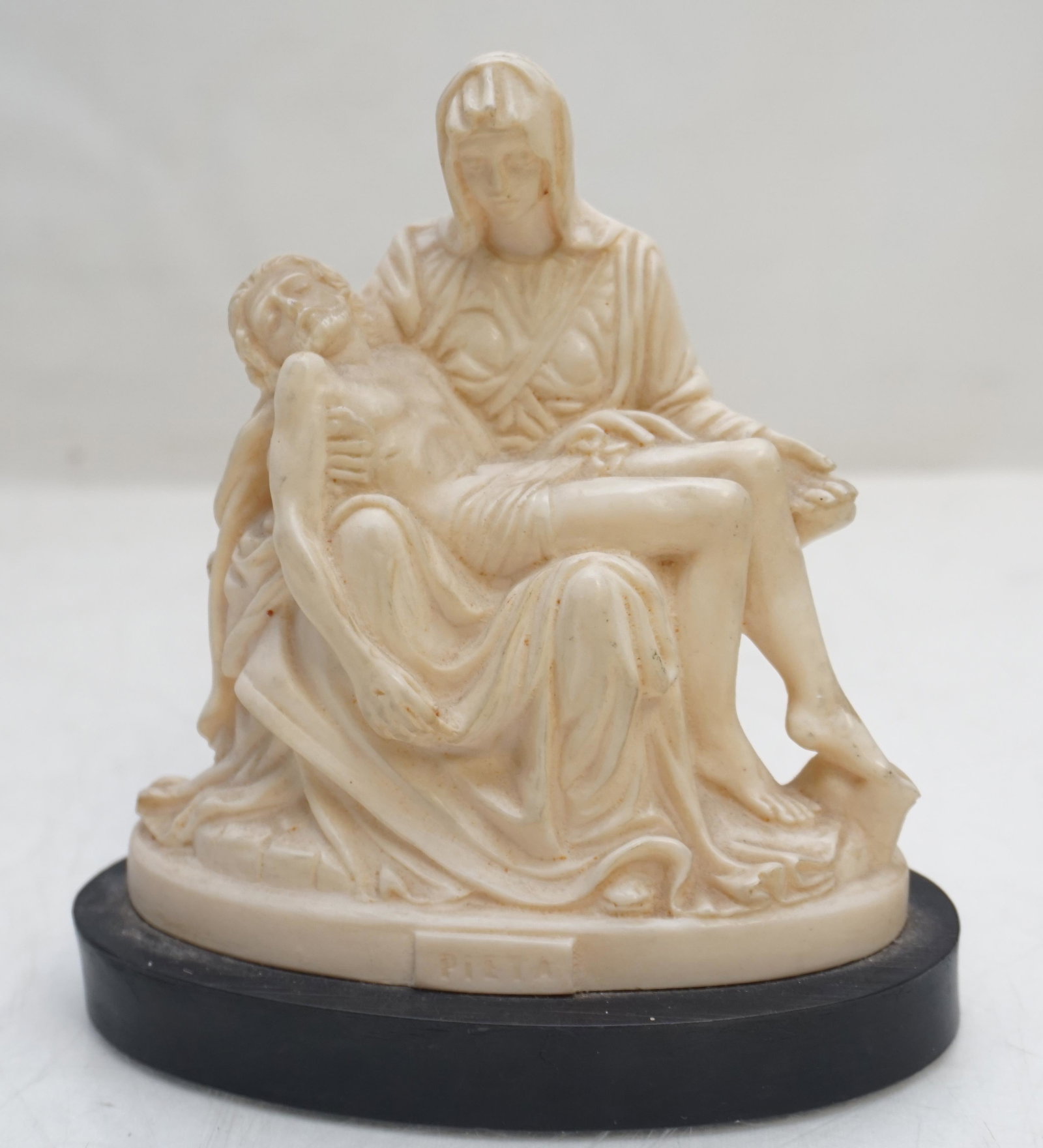 BIANCHI PIETA STATUE: Bianchi Alabaster Composite Statue after Michelangelo’s famous Pieta.With original tag and label on the bottom. Made in Italy by Italian sculptor G. Ruggeri for the well known Bianchi sculpture manu
