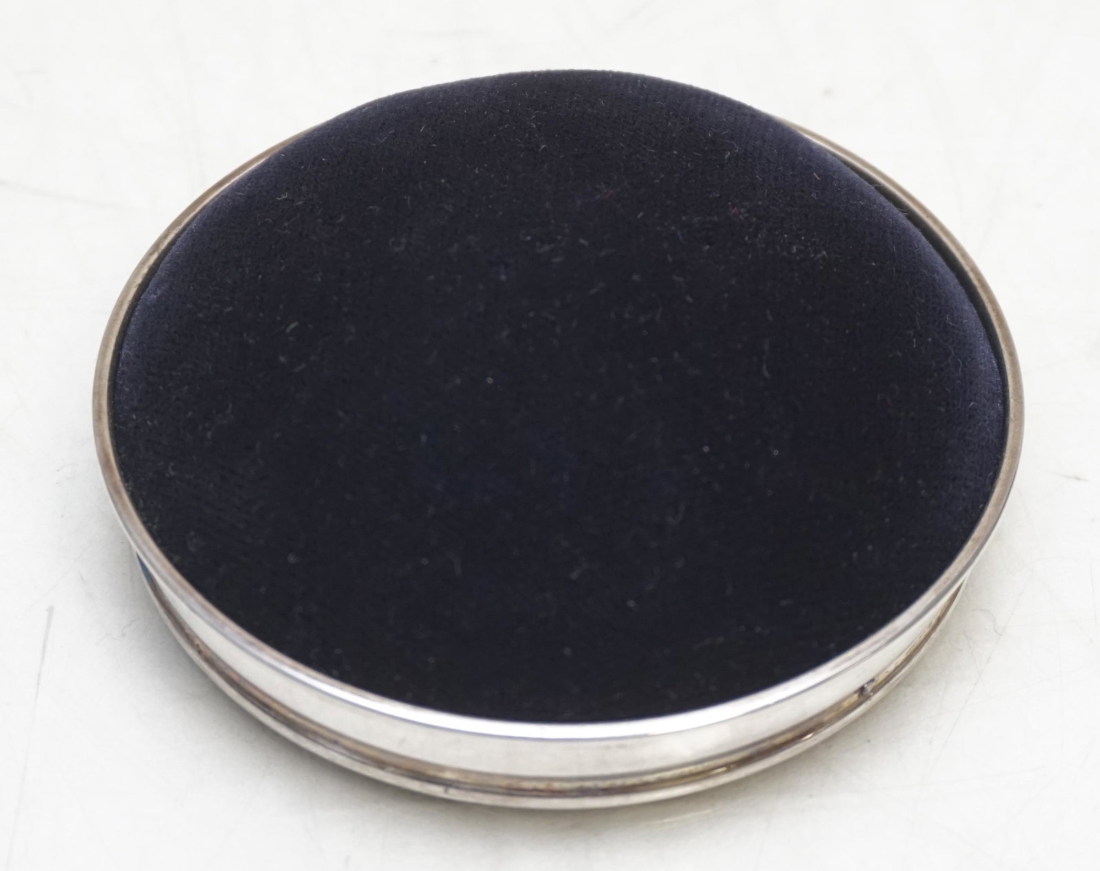 STERLING SILVER PIN CUSHION: Sterling Silver Framed Pin Cushion. Blue Velvet. Measures 3"x3"x1". In original Black Box. Weight in Box 3 oz. PROVENANCE: A Charleston SC Private Estate