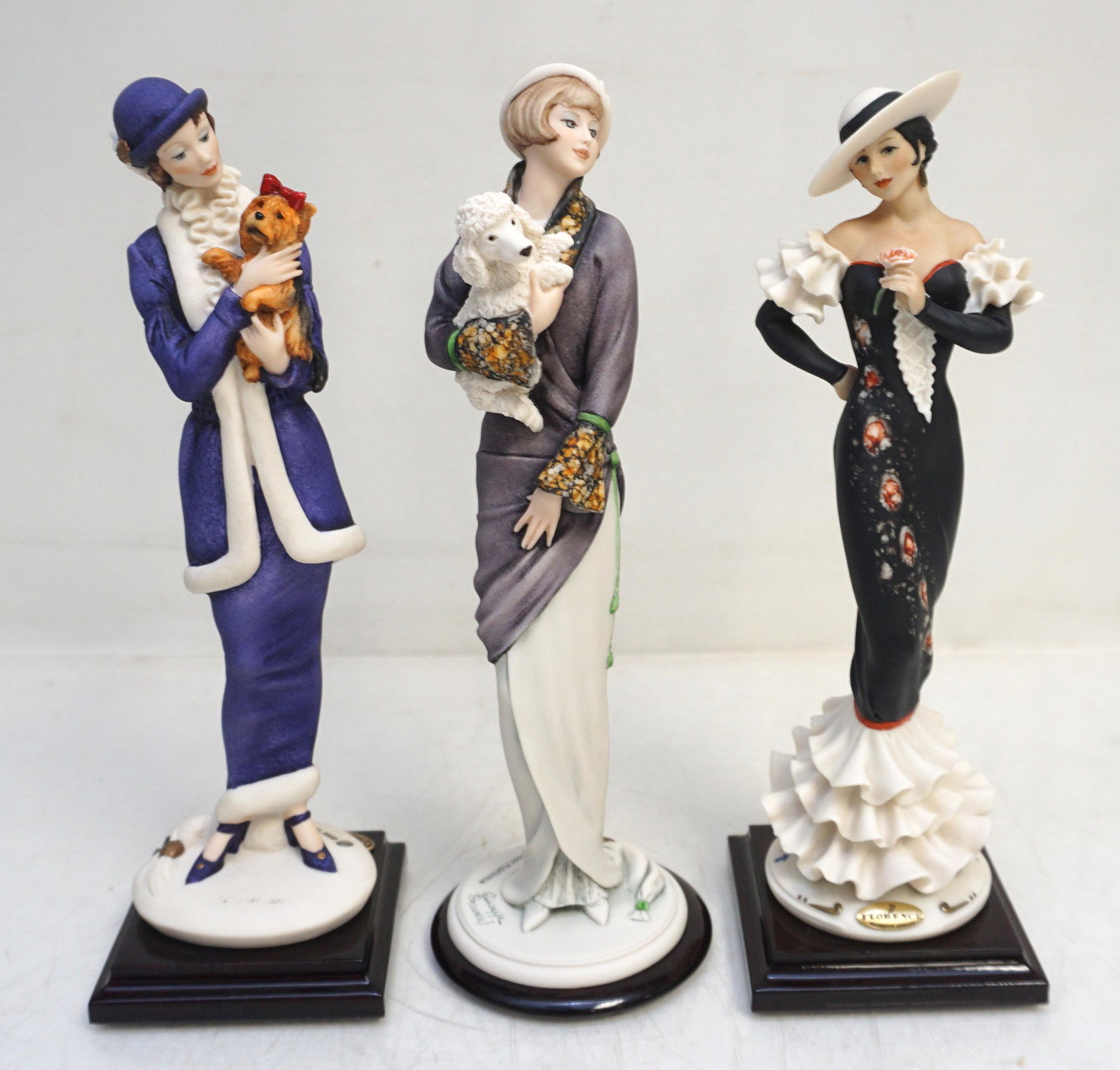 3 GIUSEPPE ARMANI FLORENCE FIGURINES: Three Giuseppe Armani, Florence Sculpted Figurines. Bridget with Poodle, Lady in Purple with Yorkie, Carmen with Rose. All Approximately 10" tall. Weight on all 2 pds 10 oz. PROVENANCE: A Private Char