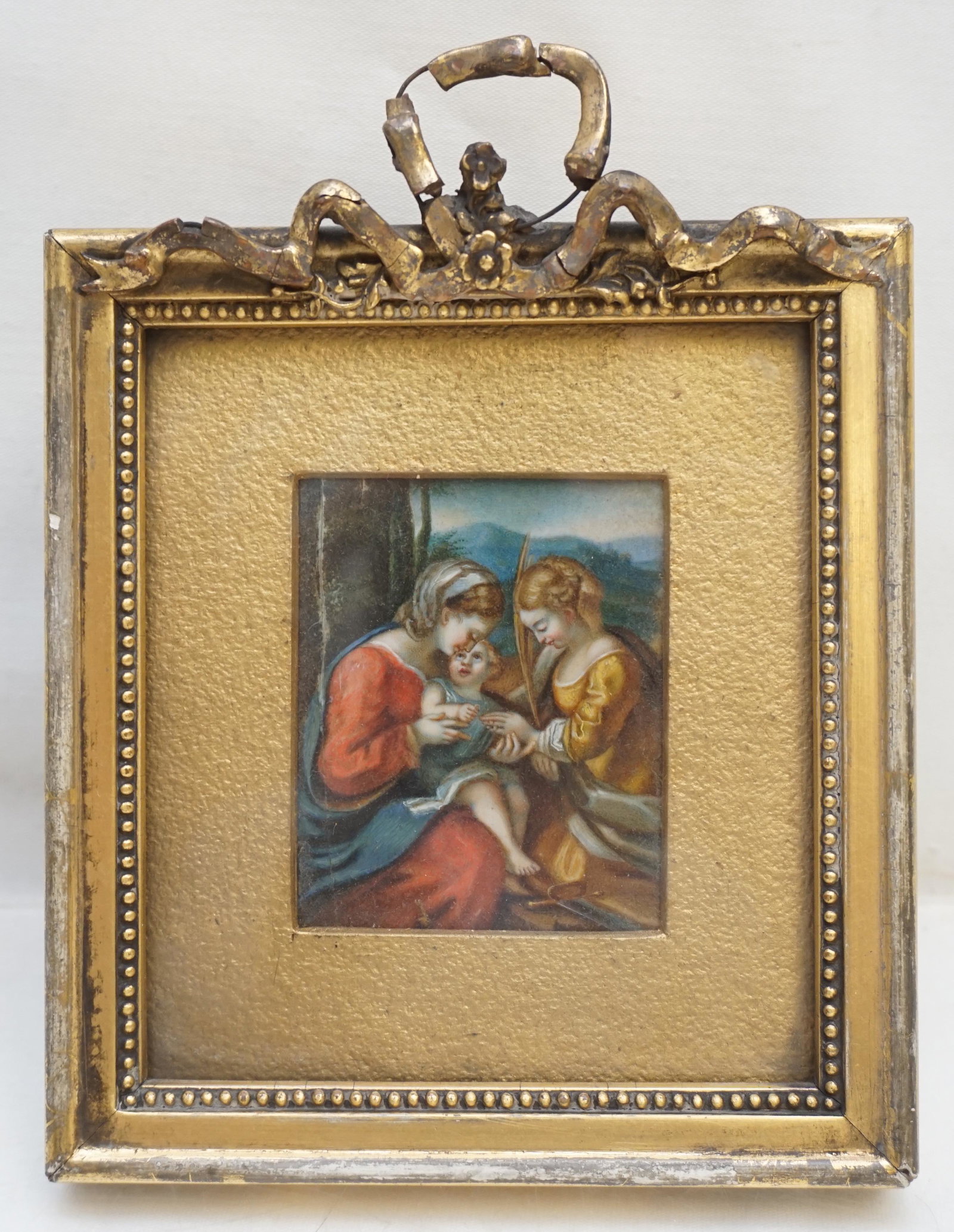 MINIATURE OIL MADONNA AND CHILD: Antique 19th c. French Miniature Oil of the Madonna with Jesus and Saint Martha. In the original frame. Loss to gesso on frame. Split to panel left side. Measures 5"x6 1/2"x1". Weight 6 oz. PROVENANCE