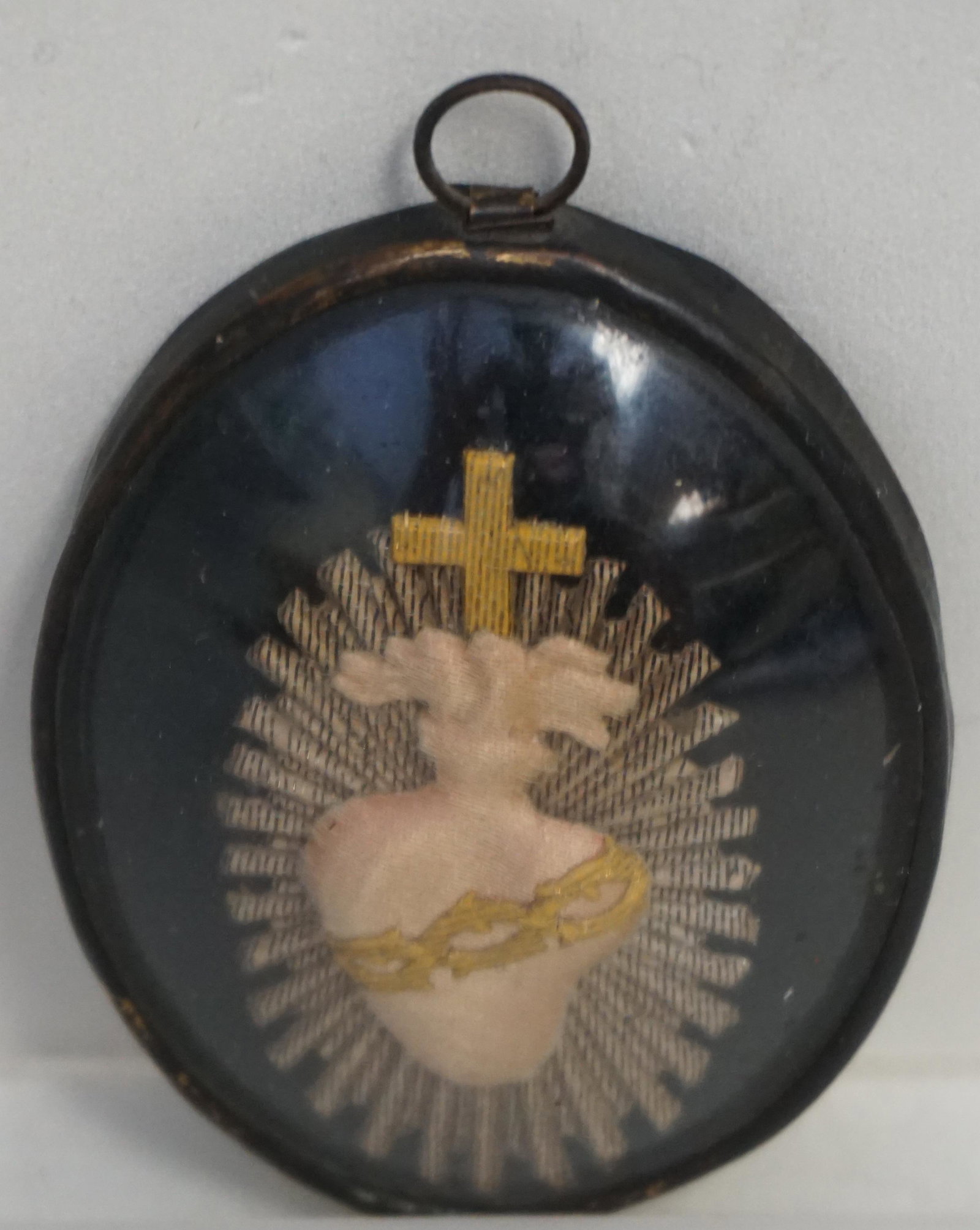 ANTIQUE CONVENT SACRED HEART RELIQUARY: Antique French Catholic Convent Needlework Sacred Heart ex Voto Reliquary. Black lacquer metal frame and back. Under Bubble Dome. Measures 2 1/2"x2". PROVENANCE: A NYC / Charleston Private Estate
