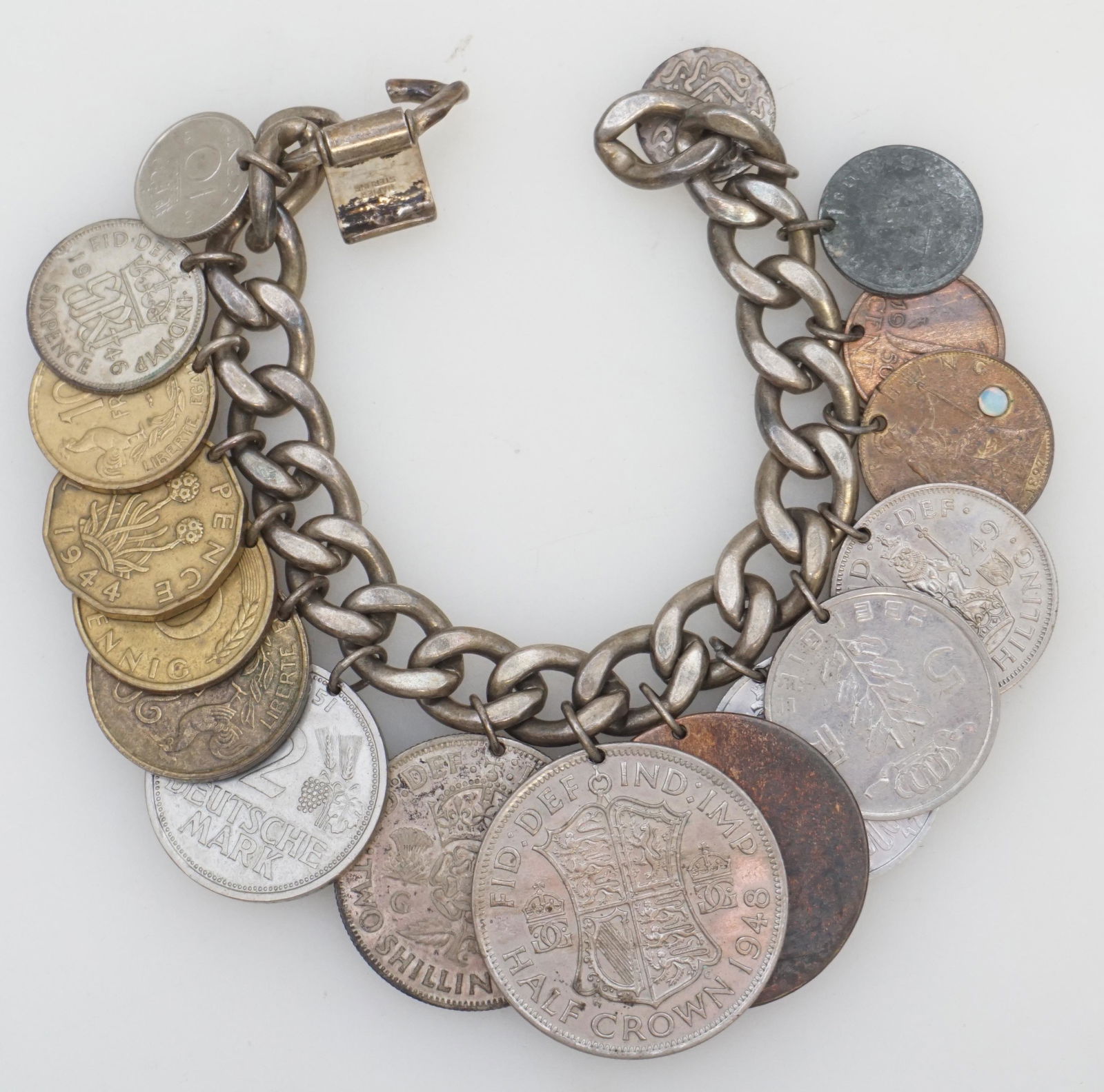 STERLING SILVER COIN BRACELET: Vintage Mid Century Sterling Bracelet with 17 Vintage and Antique Coins. Countries include Germany, France and England. One 1897 Farthing is set with a small Opal Measures 6 1/2". Eright 4.6 oz. PROVE