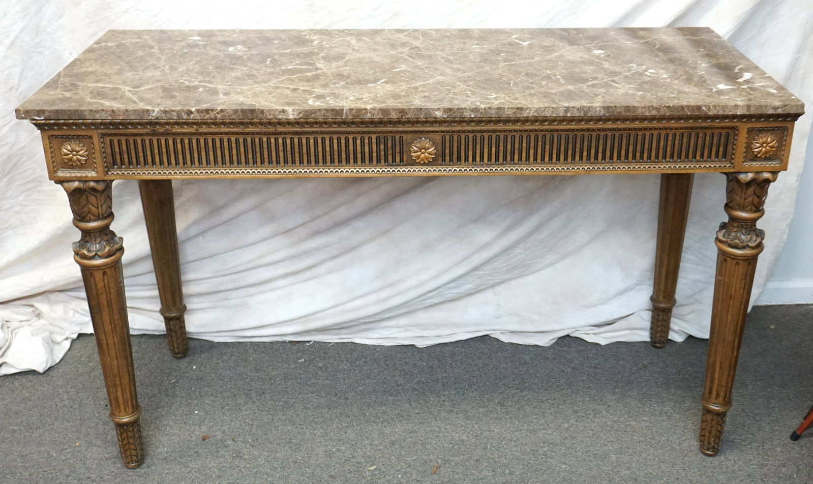 EMPERADOR DARK MARBLE TOP: Elegant 20th c. Louis XVI Style Carved Console Table with Emperador Dark Marble Top. Measures 58 1/2" long x23 1/2" wide x35" tall. PROVENANCE: A Private Charleston SC Estate. ***Pickup only or Shippi