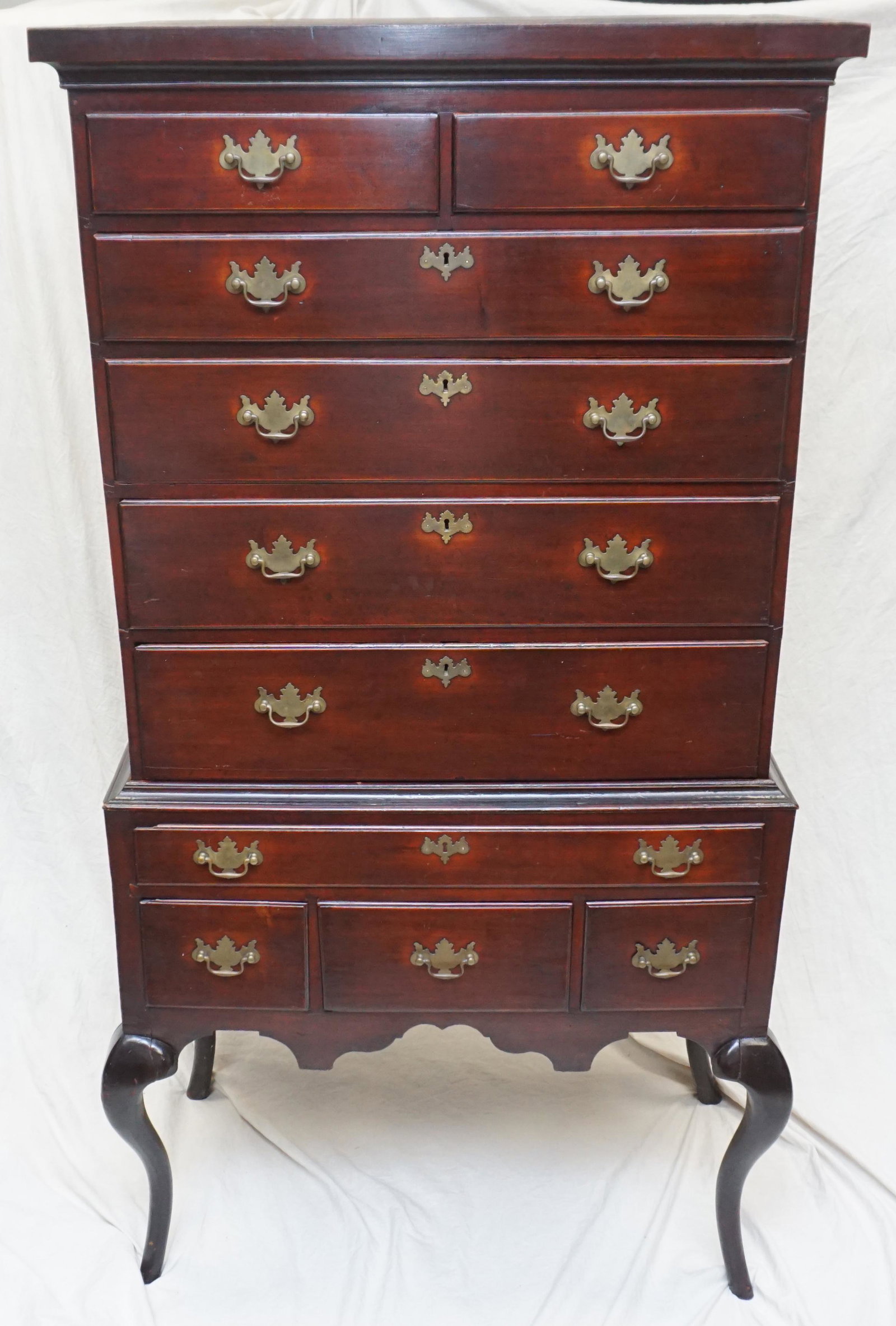 18th c QUEEN ANNE MAHOGANY HIGHBOY CHEST: Antique Queen Anne Mahogany Highboy Chest, 18th c., a two part chest with flat top, the stepped cornice over ten drawers, rising on cabriole legs, the pulls appearing original, single board hand chamf