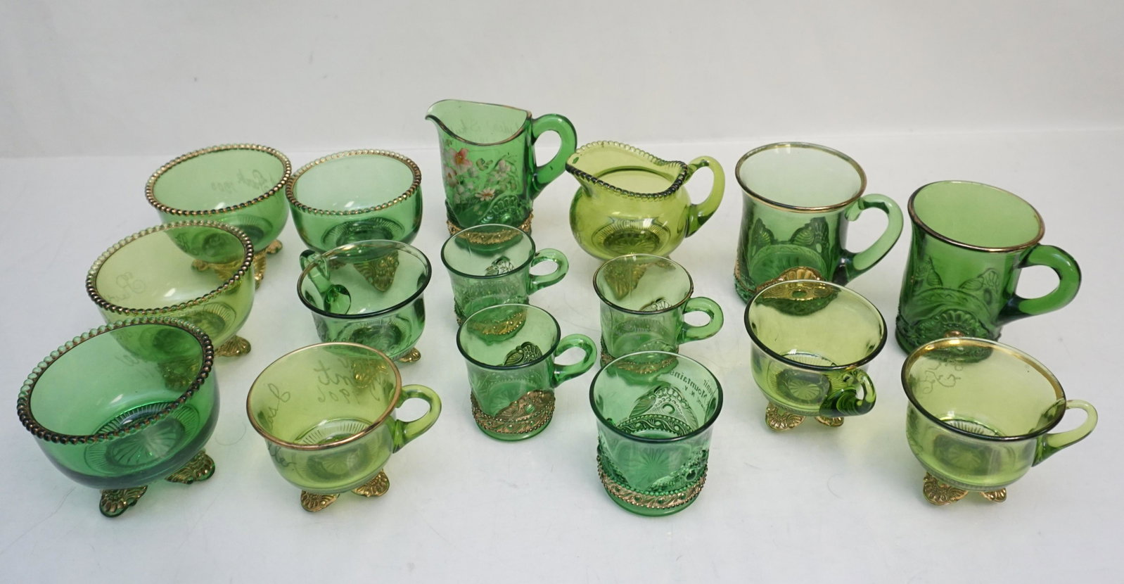 16 PC EAPG COLORADO / JEWELED MEDALLION CUPS: EAPG US Glass Green Colorado Glass / Lacy Jeweled Medallion.Sugar Bowls, Creamers, cups and mugs. All except four are with personalization or were souvenirs. Weight on all 6 pds 7 oz. The “Colorado�