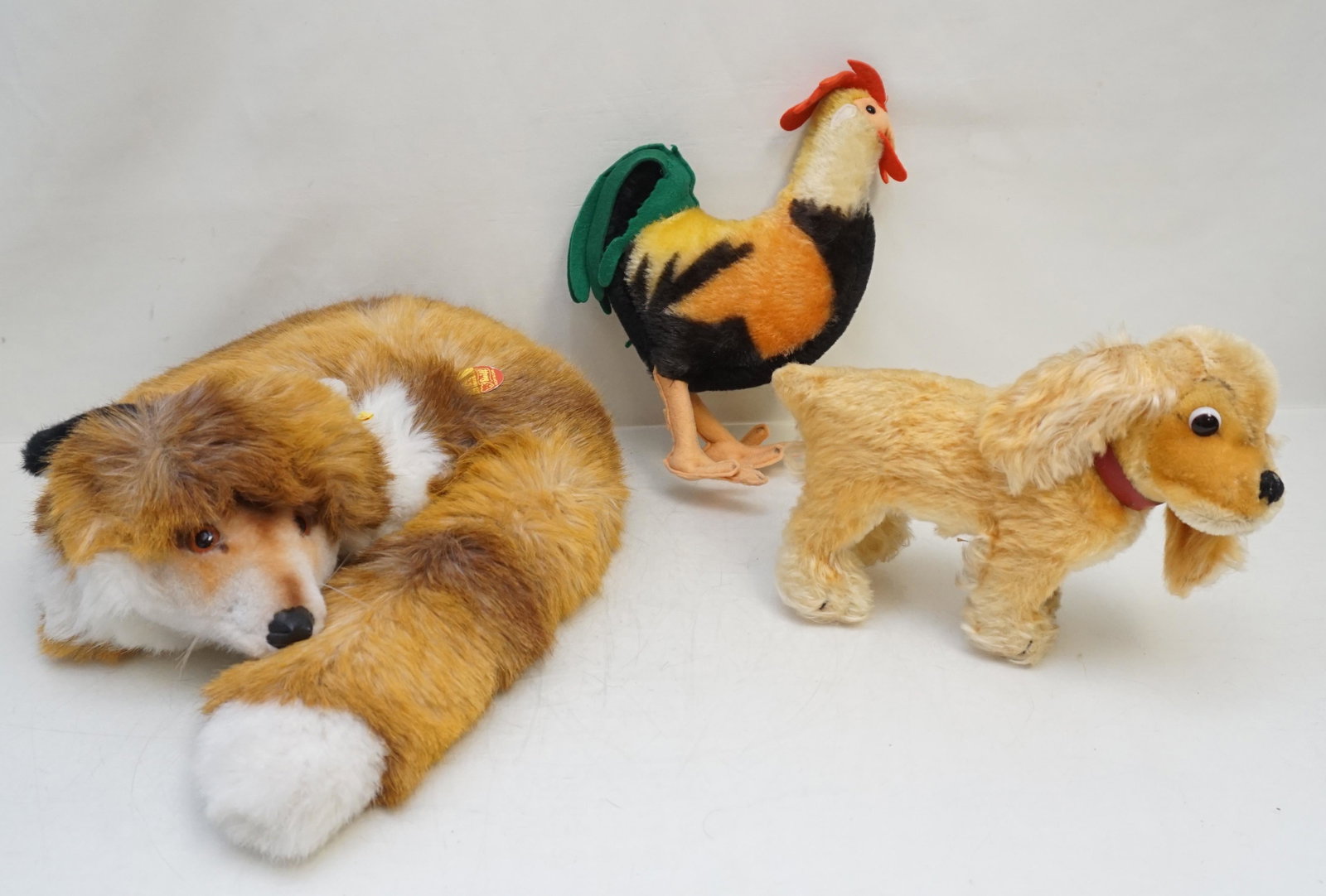 3 STEIFF FOX - COCKER SPANIEL - ROOSTER: Three Vintage Steiff Animals. 1- Steiff Mohair Fuzzy Fox, Original Button in Ear, Yellow ID Tag.14 1/2" good condition. 2- Steiff Mohair Revue Susi Cocker Spaniel Dog , 1965 to 1976, No tags, 8" long,