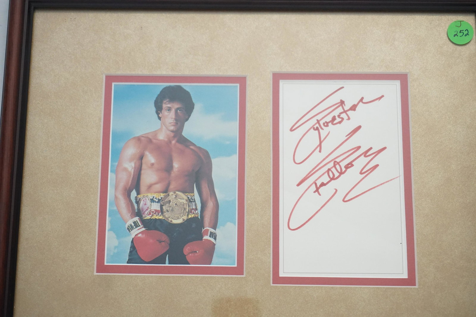 SYLVESTER STALLONE AUTOGRAPH + ROCKY PHOTO: Professionally Framed and Matted Sylvester Stallone Autograph and "Rocky" Photograph. In frame measures 14 1/2"x12"x3/4". Weight 2 pds. PROVENANCE: A Charleston SC Private Estate.