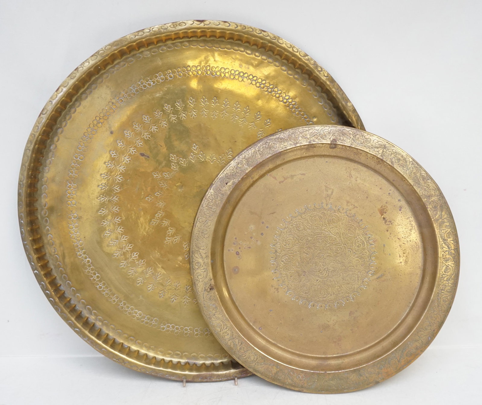 2 LARGE MOROCCAN BRASS TRAYS: Two Large Vintage Hand Hammered and Hand Etched Brass Trays from Morocco. One with markers initials on the back. Largest 21"x21". Smaller 14. Weight 7 pds 6 oz. PROVENANCE: A Private Charleston SC Est