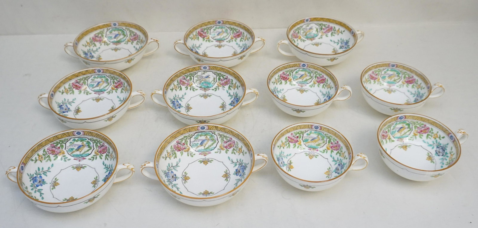 11 PC MINTON JAPONICA CREAM SOUP & CUPS: 11 Piece Minton China "Japonica" c. 1915. 7 Cream Soup Bowls 4 1/2"x6"x 1 3/4". 4 Cups 3 1/4"x4 1/4"x2". Weight on all 4 pds 6 oz.PROVENANCE: A Private Charleston SC Estate.