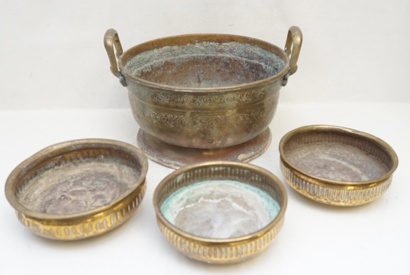 4 pc MOROCCO BRASS POT & BOWLS: Four Vintage / Antique Hand Hammered and Hand Etched Brass Pot and Bowls from Morocco. Large Pot 13"x11 3/4"x8 1/2". Round Bowls 1 at 7 1/2" and 2 at 6 3/4". Weight on all 6 pds. PROVENANCE: A Private