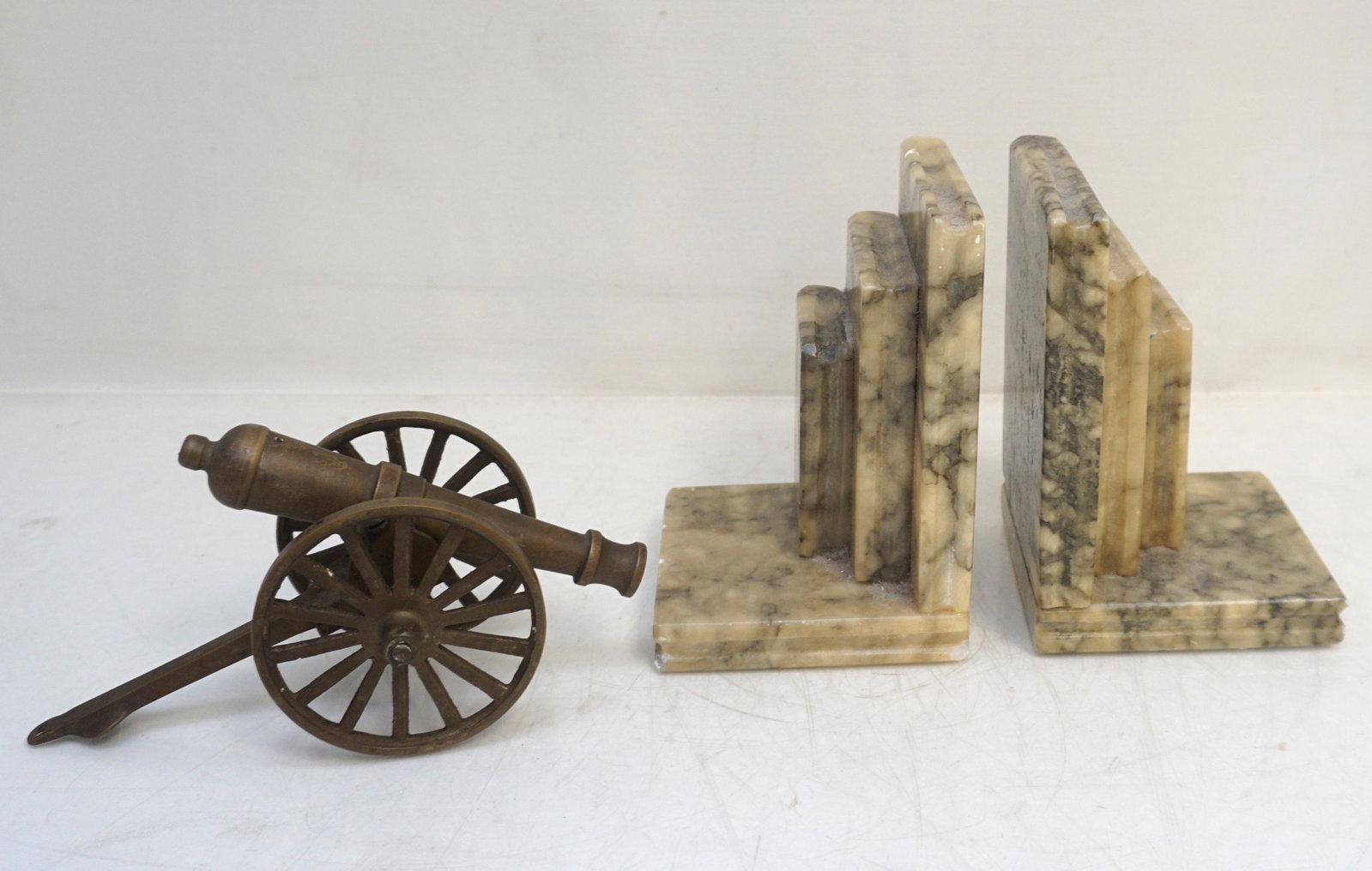 ITALIAN ALABASTER BOOKENDS + CANNON: Vintage Mid Century Alabaster Bookends Made In Italy. Each 4"x4"x5 3/4". Vintage Brass Cannon 8" long. Weight on all 7 pds.