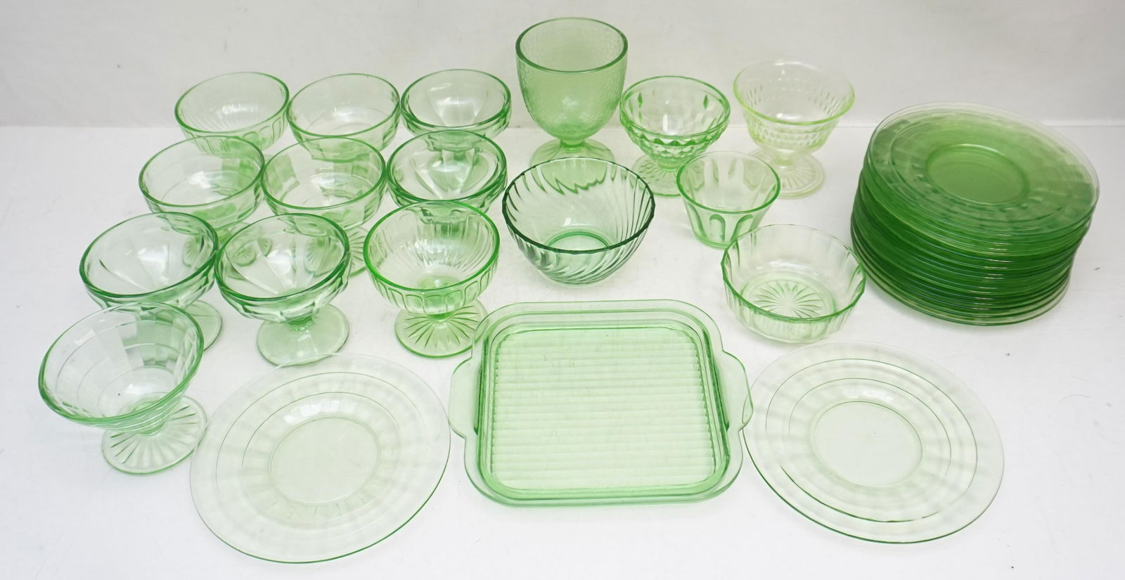 35 VINTAGE VASELINE SHERBETS +: 35 Vintage Green Depression Glass Vaseline - Uranium Items. Strong glow to all.. Varied Patterns. Including 18 Saucers at 6 1/4". 1 Square Refrigerator Dish 7 1/2"x6 1/2". 12 Sherbets Tallest 3 1/":.