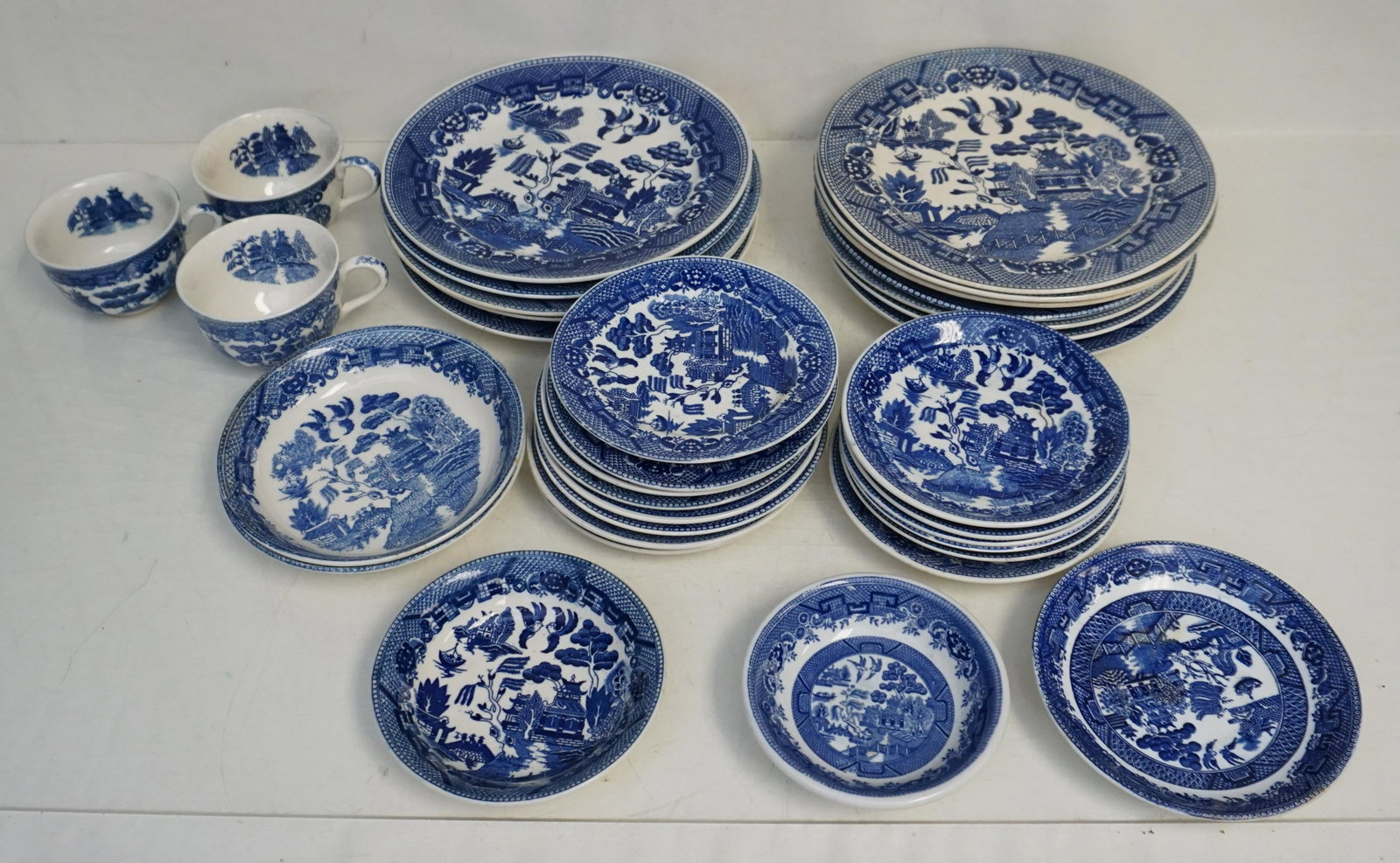34 PC VINTAGE BLUE WILLOW WARE: 34 Piece of Vintage Blue Willow Ware Japan. 12 Dinner Plates Varied approx 9 1/4". 3 Cops, 6 saucers, 7 Bread and Butter Plates, 6 bowls varied. Weight on all 22 pds, ***Pickup only or Shipping on thi