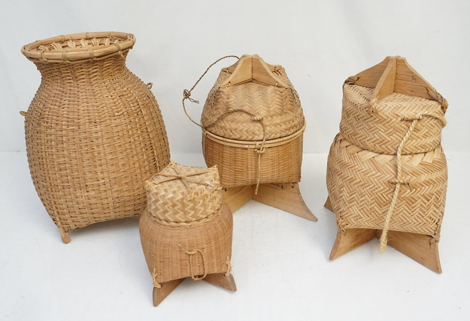 4 SOUTHEAST ASIAN RICE BASKETS: Three Vintage Southeast Asian bamboo basket to hold rice and other dry goods. Widely used in Laos, Cambodia and Thailand. In addition there is a Open Woven Basket from Cambodia. 11 1/2" tall. Weight o