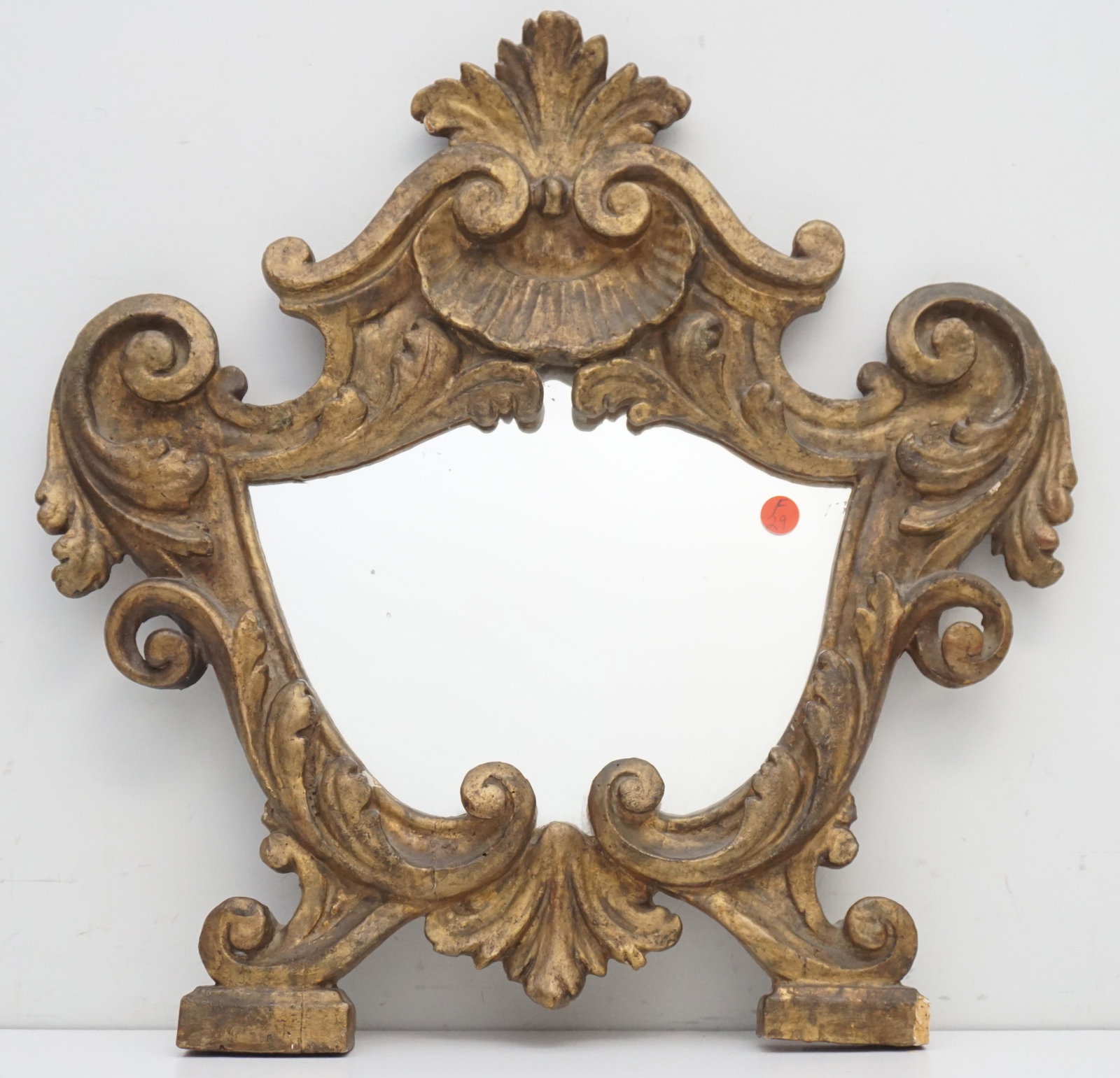 ANTIQUE FRENCH CARVED MIRROR: Antique French Carved Mirror. Label on back states 18th c. Replaced mirror. Measures 20"x20"x 1 1 /2". Weight 3 pds. PROVENANCE: A Private Charleston SC Estate