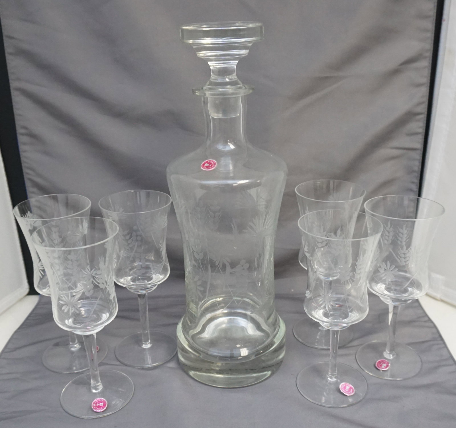 ETCHED ROMANIAN DECANTER SET: Etched Vintage Mid Century Romanian Crystal Decanter Set. Decanter 13" and Six Wine Glasses 6 1/2". Weight on all 4 pds 10 oz. Still retains the original stickers on all but 1. PROVENANCE: A Charlesto