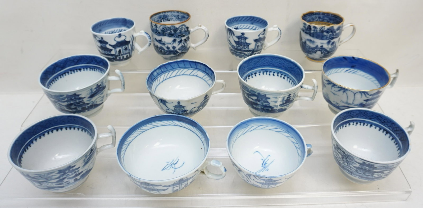 12 CHINESE BLUE CANTON CUPS: Twelve (12) Chinese Export Blue and White Canton Cups. Varied sizes and ages. Weight 3 pds. From the collection of Dr. Fraser Wilson of Charleston, SC. Dr. Wilson's Blue Canton collection was so compl