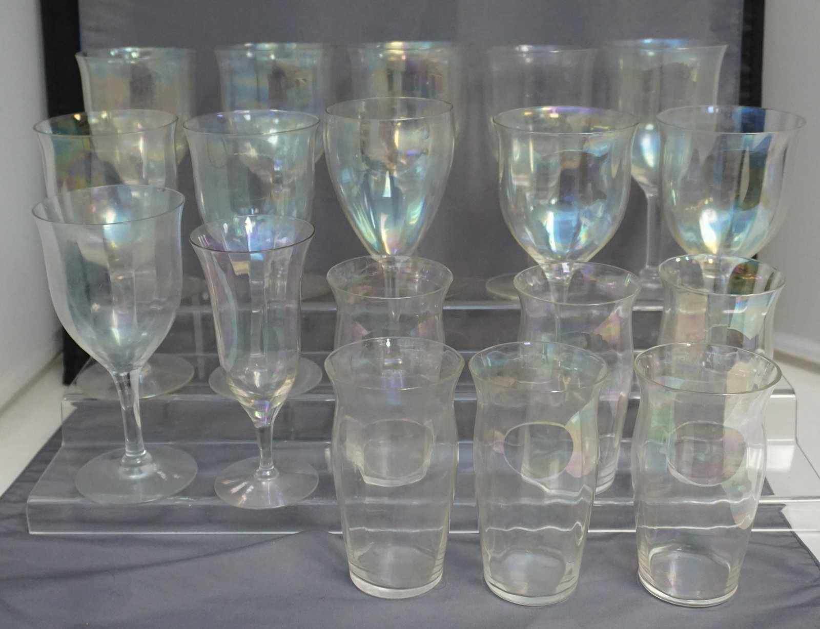 18 PC ART DECO IRIDESCENT GLASS: 18 Piece Vintage Art Deco Iridescent Glass. 6 Fluted Tumblers 4 1/4", one with tiny nick to rim. 10 Fluted Wine Glasses 6 1/2". 1 Wine 6 3/4". 1 Fluted Champagne 6". Weight 5 pds. PROVENANCE: A Privat