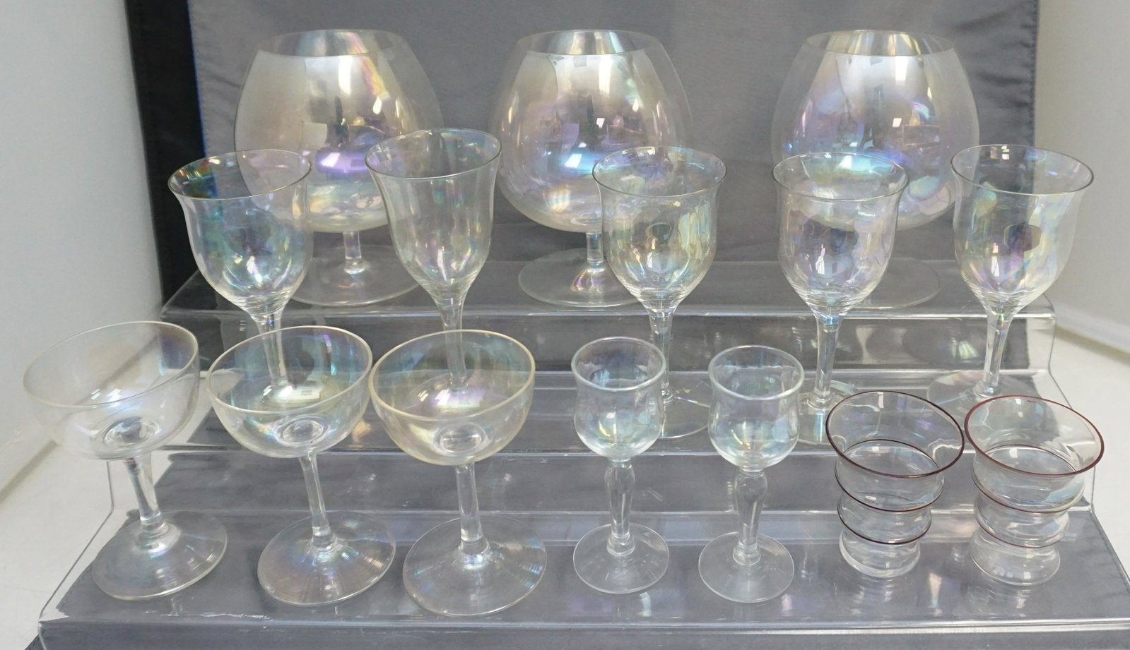15 PC ART DECO IRIDESCENT GLASS: 15 Piece Vintage Art Deco Iridescent Glass. 3 Brandy Snifters 3 1/2" wide and 5 1/2" tall. 3 Champagne 3 1/4". 5 Sherry Glasses 4 are 4 3/4" and one is 5 1/4". 2 Ribbed Shot / Cordial Glasses 2 1/8". 