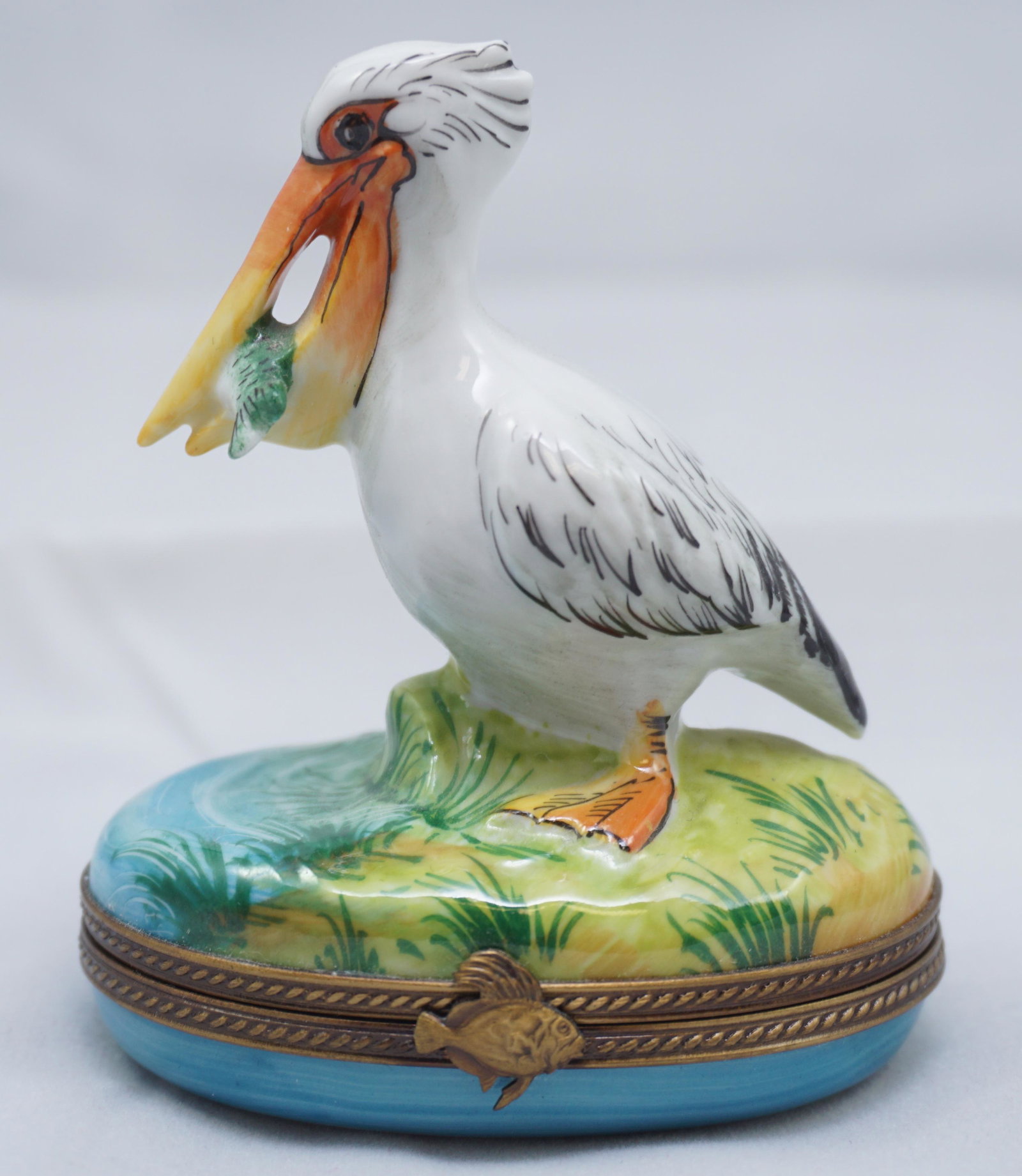 LIMOGES ROCHARD PELICAN BOX: Retired Limoges Rochard Pelican Box. The Limoges "Pelican with Fish" box is artfully and colorfully hand painted by premier artists using many of the same techniques that were used during their introd