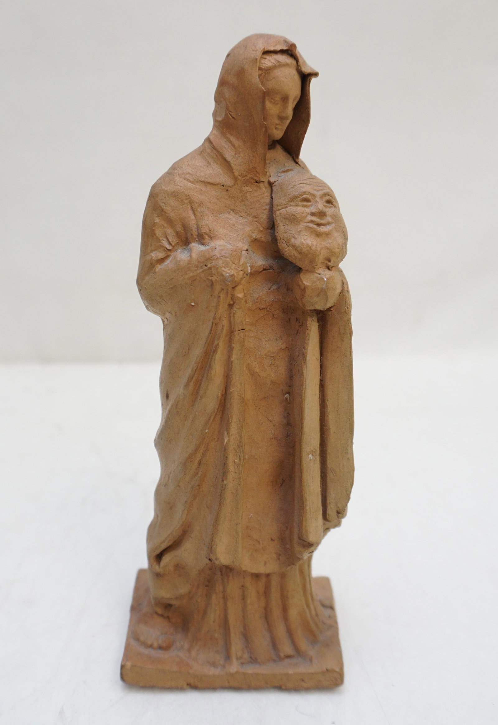 GREEK TANAGRA TERRACOTTA THEATRICAL FIGURE: Ancient Greek Woman holding a theatrical mask. Terracotta figurine made in Tanagra. Greek, c. 4th-3rd Century B.C. Condition: Wear, Chip to veil front. 7" tall. Weight 10 oz. PROVENANCE: A Private NYC