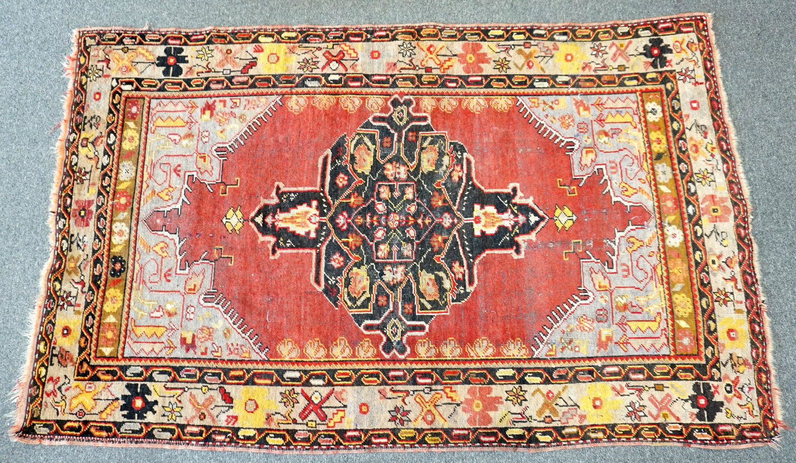 SEMI ANTIQUE TURKISH HAND KNOTTED RUG: Semi Antique Hand Knotted Turkish Wool Rug c. 1920s. Measures 48"x79". Wt approx 12 pds. PROVENANCE: A Private Charleston SC Estate