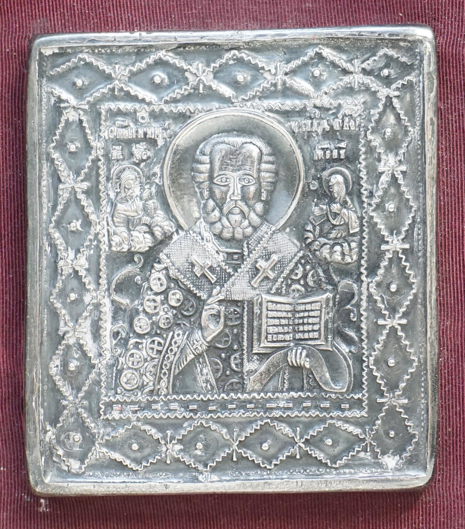 HENRYK WINOGRAD ICON (POLISH/AMERICAN 1917-2008): Henryk Winograd (Polish/American 1917-2008) Orthodox Christian icon depicting St. Nicholas in fine hand hammered silver repousse. Icon 4"x4 1/4".In frame 11"x12"x21/4". Weight 1 pd 5 oz. PROVENANCE: A