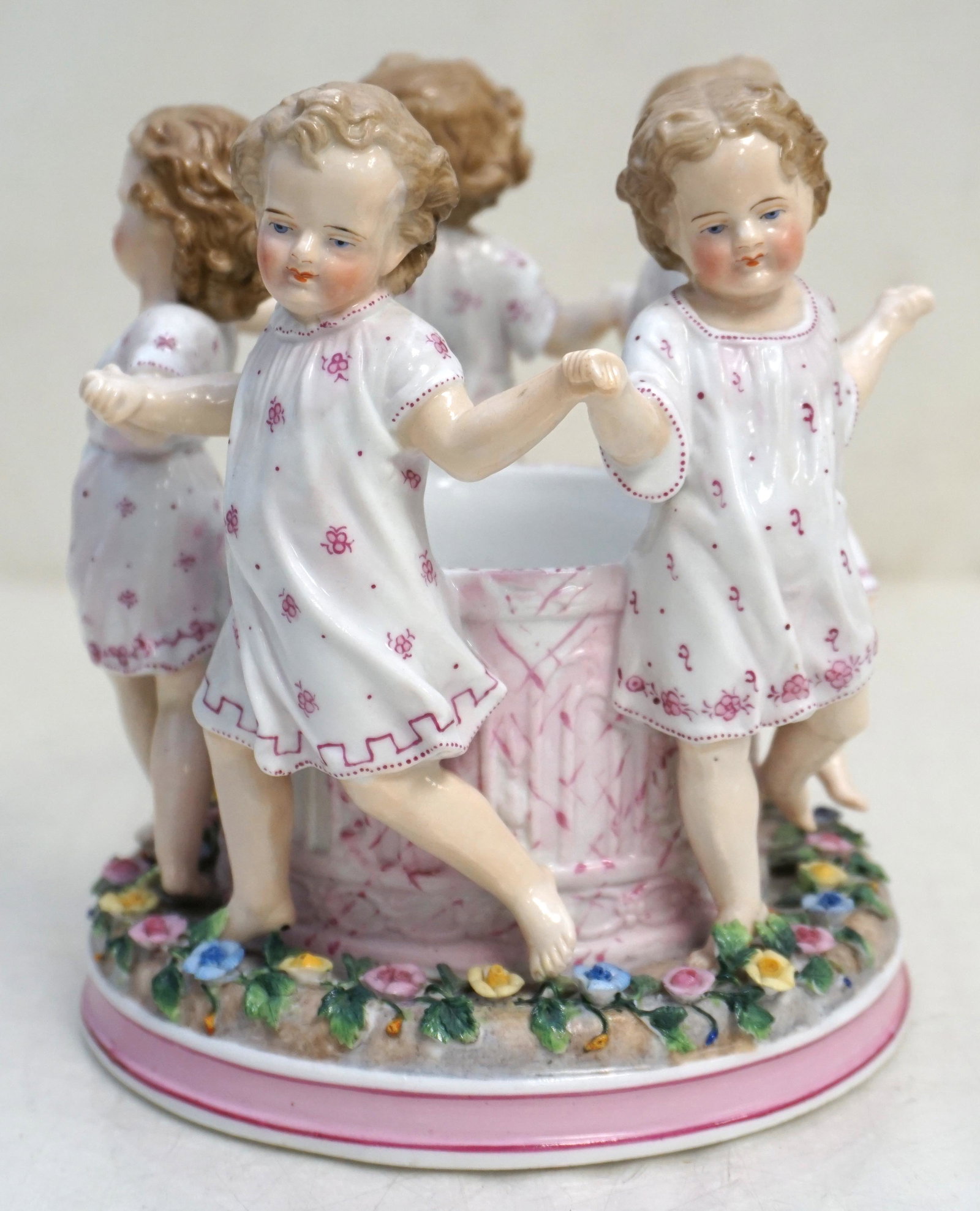 RUDOLSTADT PORCELAIN FIGURAL GROUP: Rudolstadt Porcelain Figural Group. German, Ernst Bohne Sohne (1854-19210, hand-painted depicting five girls holding hands and circling an open well playing "Ring Around the Rosy", marked "EBS", blue 