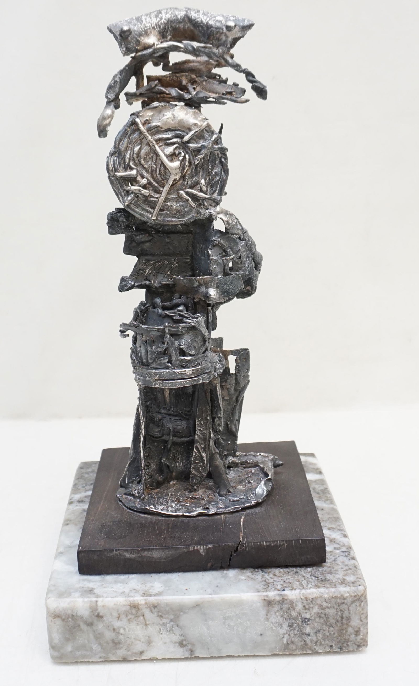 MID CENTURY BRUTALIST SCULPTURE: Brutalist School (mid 20th c.), abstract clock tower, bronze silvered sculpture, inscribed H.G.E.B. Original hardwood base on more recent granite base with beveled edges. Sculpture and original base i