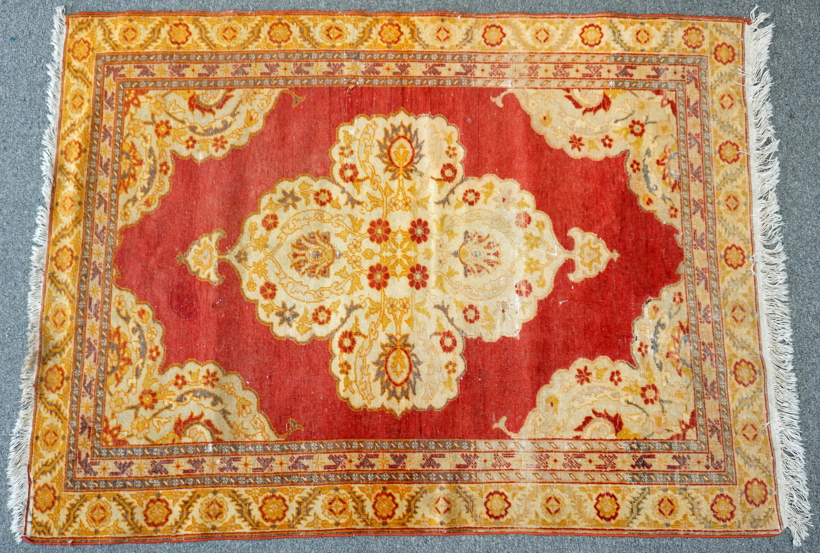 SEMI ANTIQUE OUSHAK RUG: Semi Antique early 20th century Oushak Rug. With pale gold medallion on red ground, stepped edge spandrels, red, gold, and olive highlights.42"x61". Wt 6 pds. PROVENANCE: A Private Charleston SC Estat