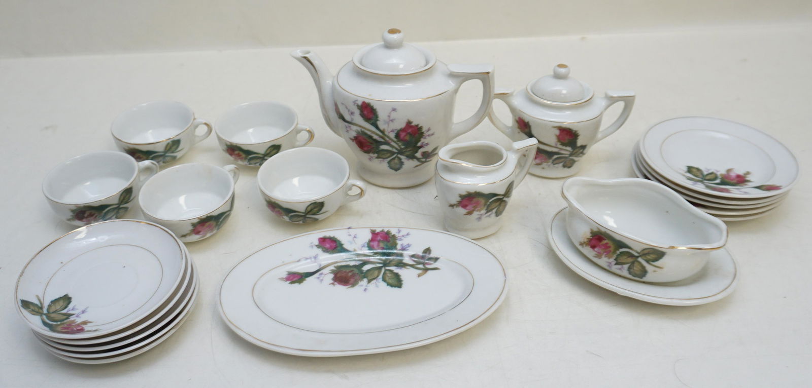 20 PC VINTAGE CHILDS TEA SET: Vintage 20 Piece Porcelain Childs Rose Bud Tea Set. Original Box c. 1950s. Made in Japan. Teapot 4". Box 13"x10 1/2"x3". Weight on all 3 pds 3 oz. PROVENANCE: A Private Charleston SC Estate.