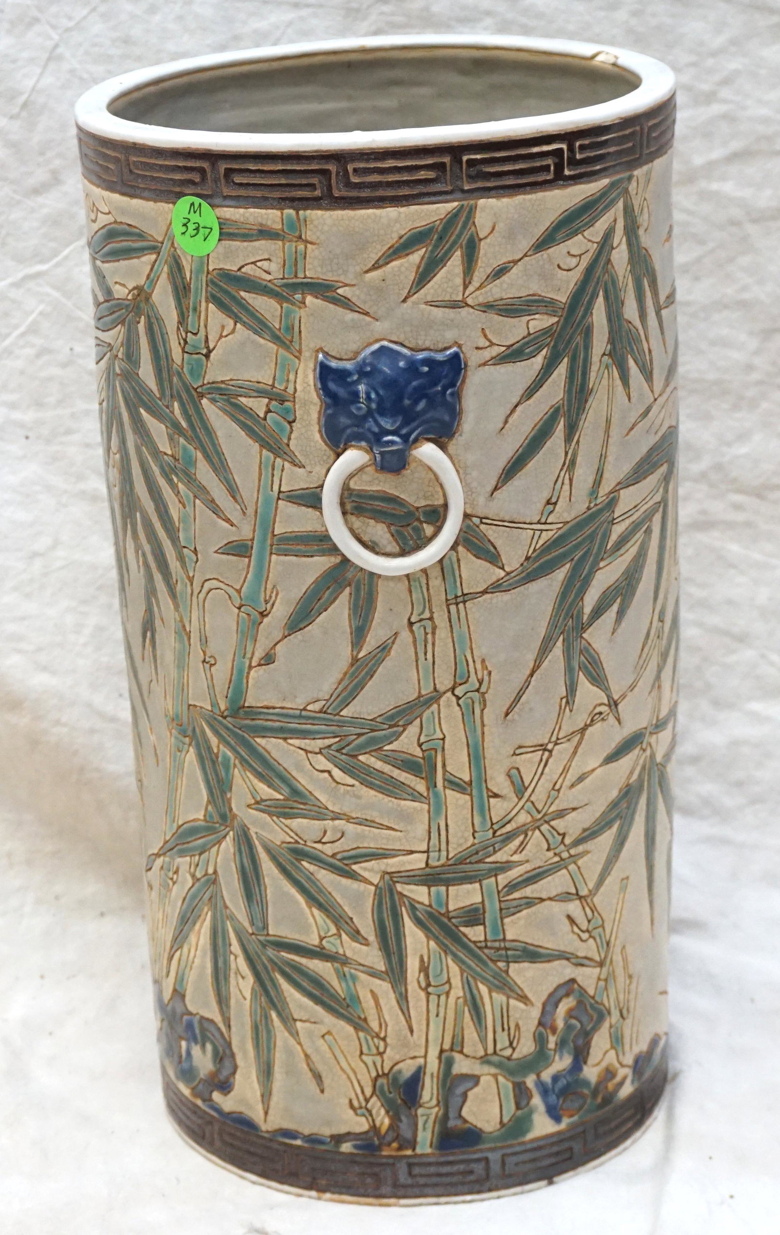 PORCELAIN UMBRELLA STAND: Chinese Porcelain 20th c. Umbrella Stand. Bamboo with Figural Lion Handles. Chip to rim . Measures 8"x8"x15". Weight 13 pds. PROVENANCE: A Private Charleston SC Estate. ****Pickup only or Shipping on 