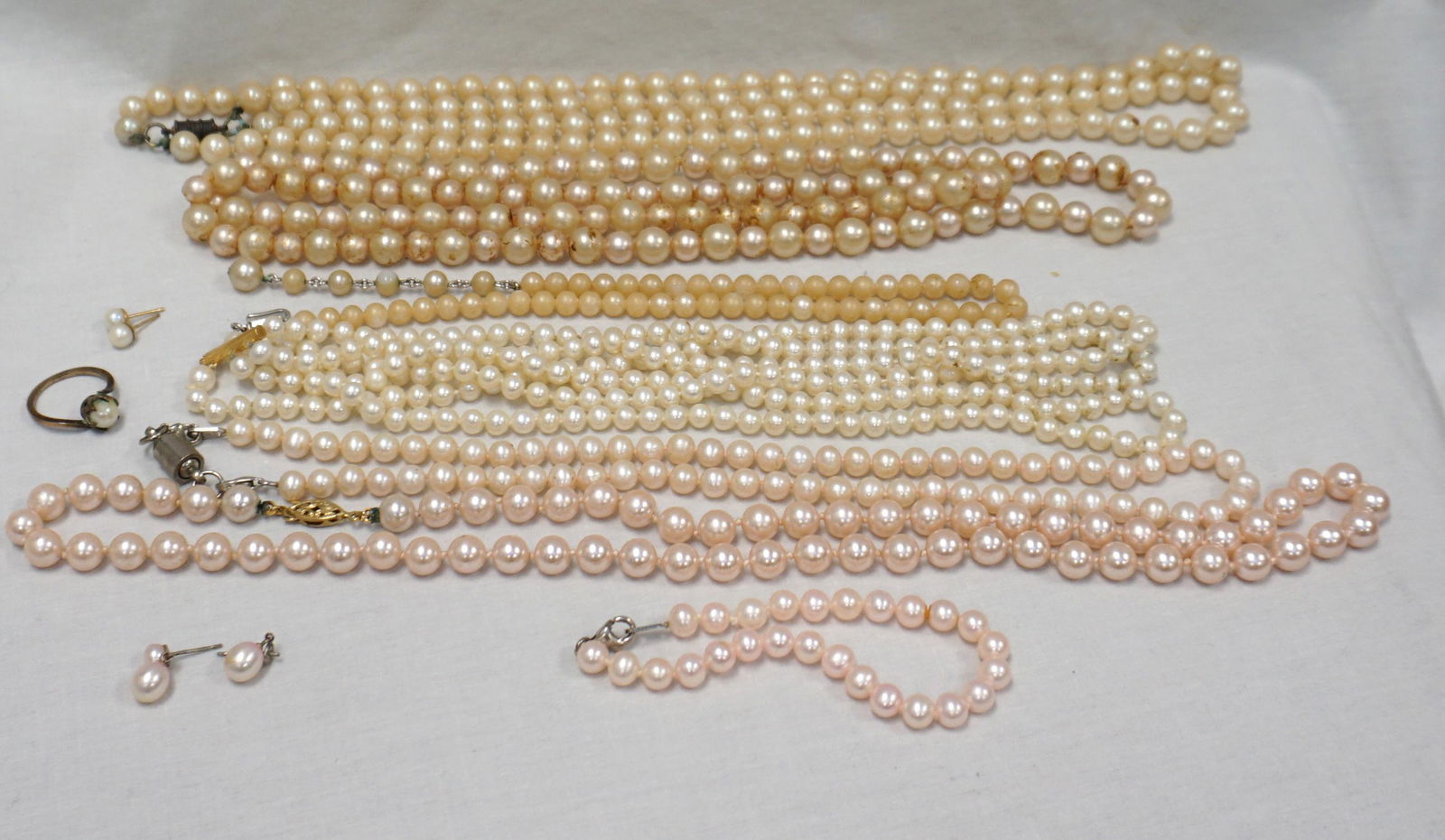 10 pc ESTATE COSTUME PEARL NECKLACES +: 10 Piece Estate Vintage Costume Pearl Jewelry. Included is a Trifari Pearl necklace. Two pair pierced earrings, no backs, gold filled pearl ring, 1 bracelet and 6 necklaces. Weight on all 12 oz.