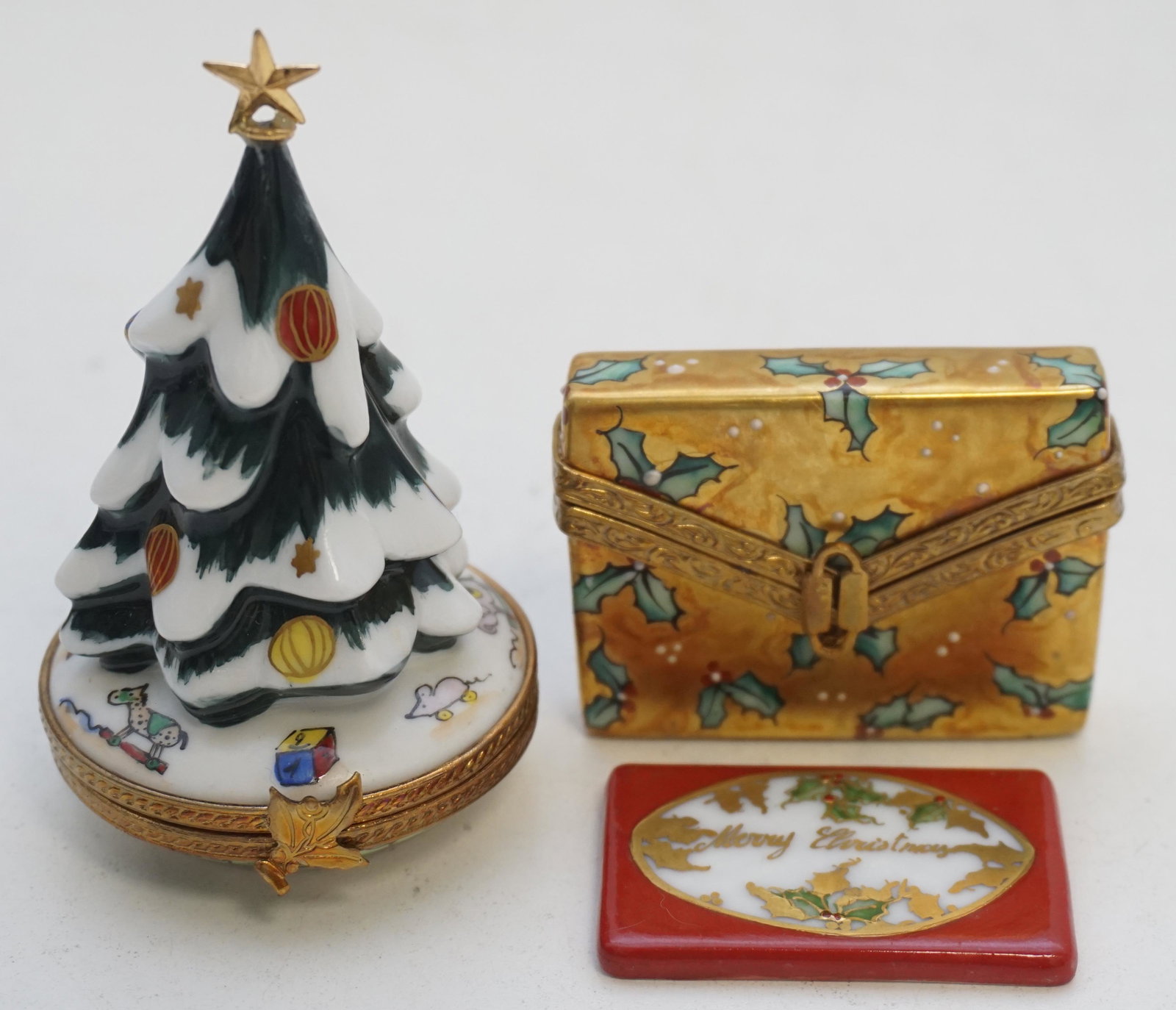 2 ROCHARD LIMOGES PEINT MAIN BOXES: Two Rochard Limoges France Peint Main Christmas Boxes. Rochard Decorated Christmas Tree 3 1/4". Rochard Gilt Holly Decorated Envelope with Christmas Card inside 1 3/4". Measures 2 1/2". Weight 3.4 oz.