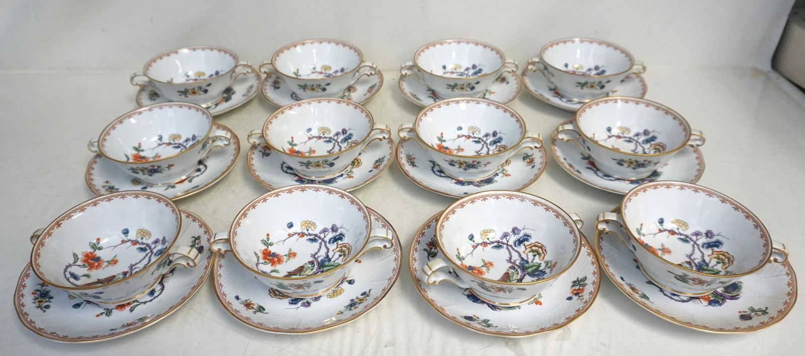 24 PC LIMOGES VIEUX ROUEN CREAM SOUP & PLATES: Set of 12 Vieux Rouen Limoges Footed Cream Soup Bowl & Saucer Sets by Bernardaud. Birds & Flowers, Basketweave Rims. 12 Soups 4 1/2". 12 Plates 6 1.2". Weight on all 6 pds 12 oz. PROVENANCE: A Private
