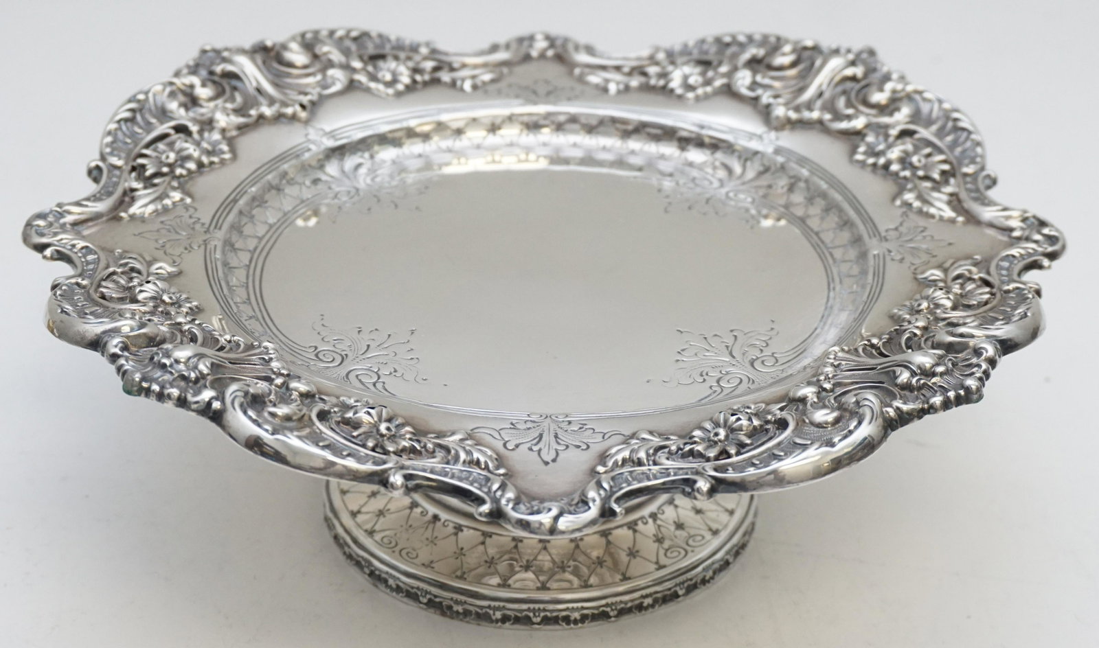 VICTORIAN ORNATE STERLING SILVER TAZZA: Ornate American Victorian Sterling Silver Tazza / Compote. Marked Sterling 4831Kx. Measures 9 1/2"x9 1/2"x3 1/4". Weight approximately 515 grams. PROVENANCE: Edwin Moore Brogdon, PhD, collection. Dr. 