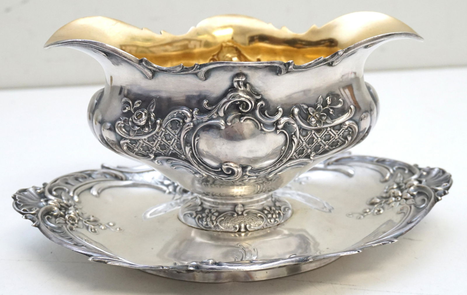 19th c GERMAN 800 SILVER REPOUSSE SAUCE BOAT &: Ornate 19th c. Antique German Bruckmann & Sohne 800 Silver Sauce / Gravy Boat with attached underplate. Gilt interior. No monograms. Weight approximately 405 grams. Measures 8 3/4"x 6 1/4"x4 1/2". PRO